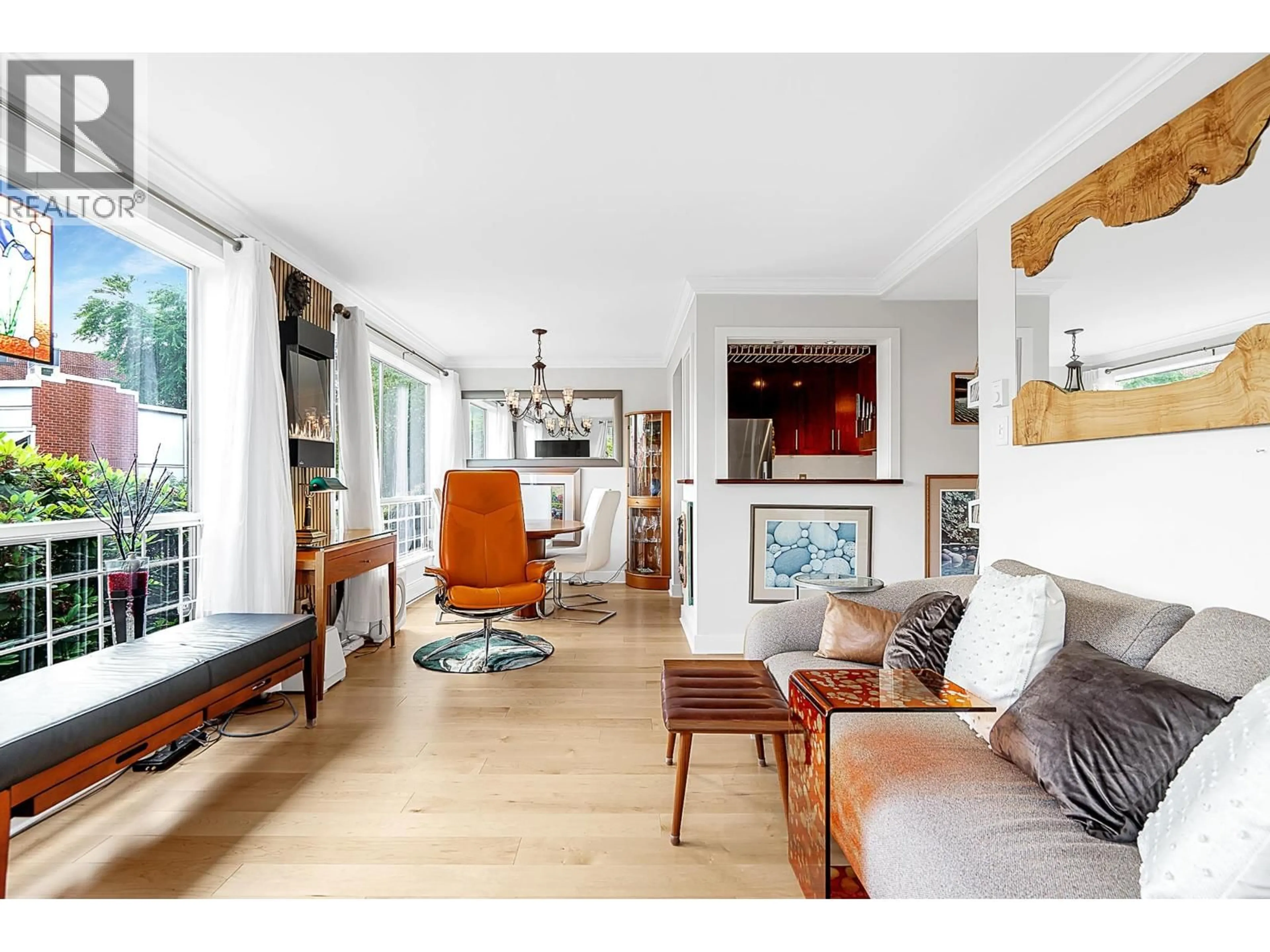 Living room with furniture, wood/laminate floor for 102 - 1530 MARINER WALK, Vancouver British Columbia V6J4X9