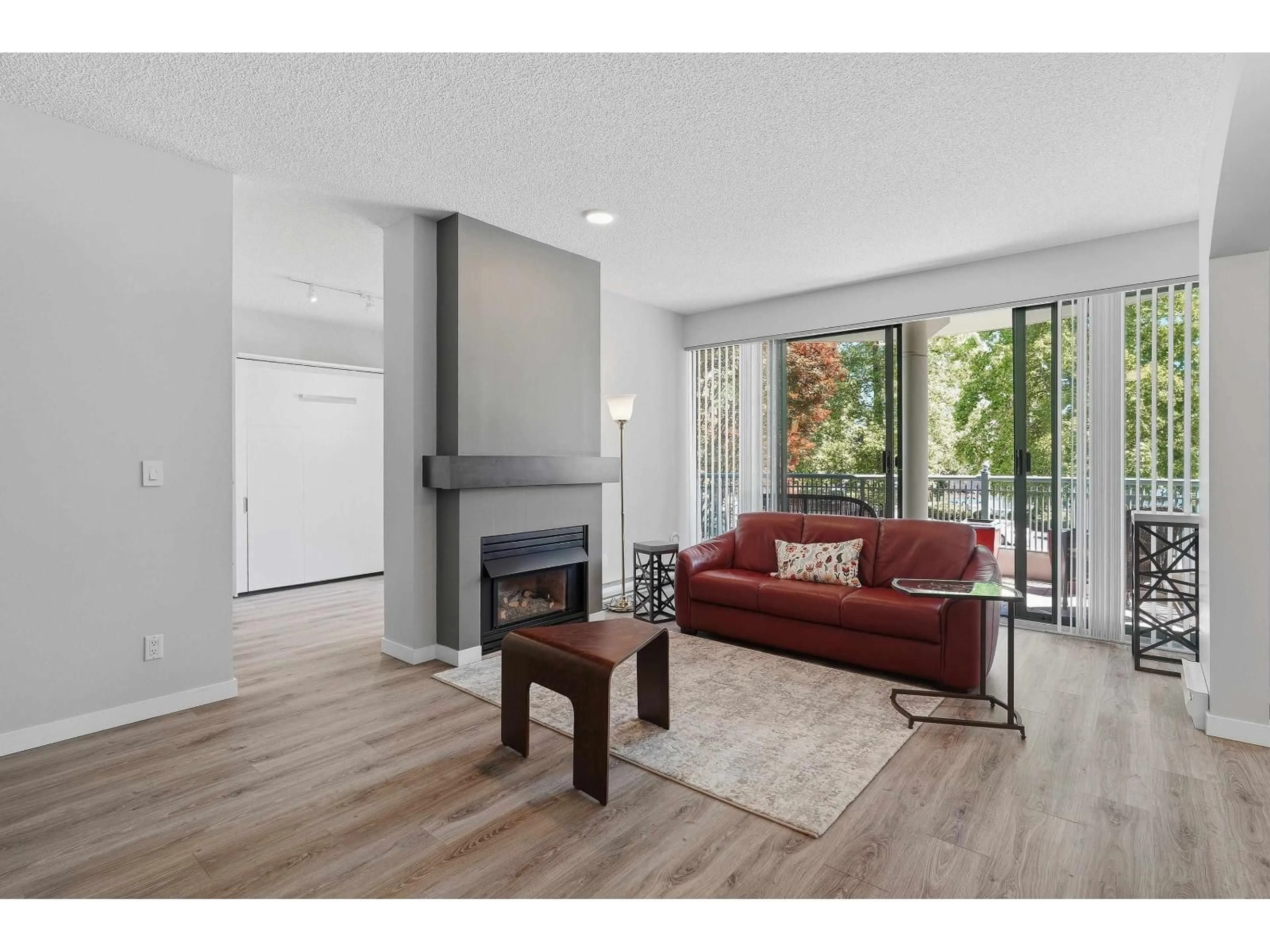 Living room with furniture, wood/laminate floor for 201 - 1705 MARTIN DRIVE, Surrey British Columbia V4A9T5