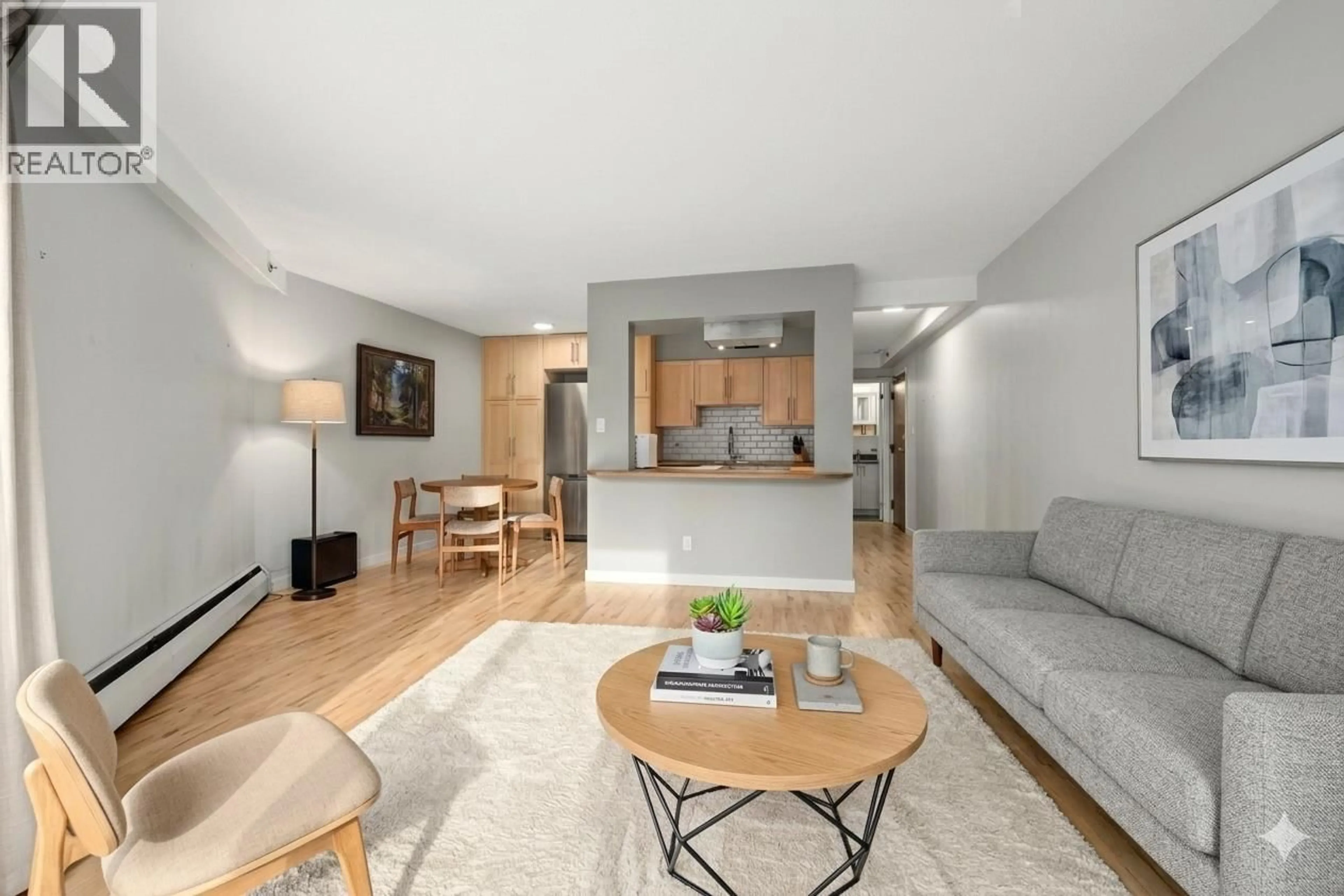 Living room with furniture, wood/laminate floor for 104 - 1549 KITCHENER STREET, Vancouver British Columbia V5L2V8