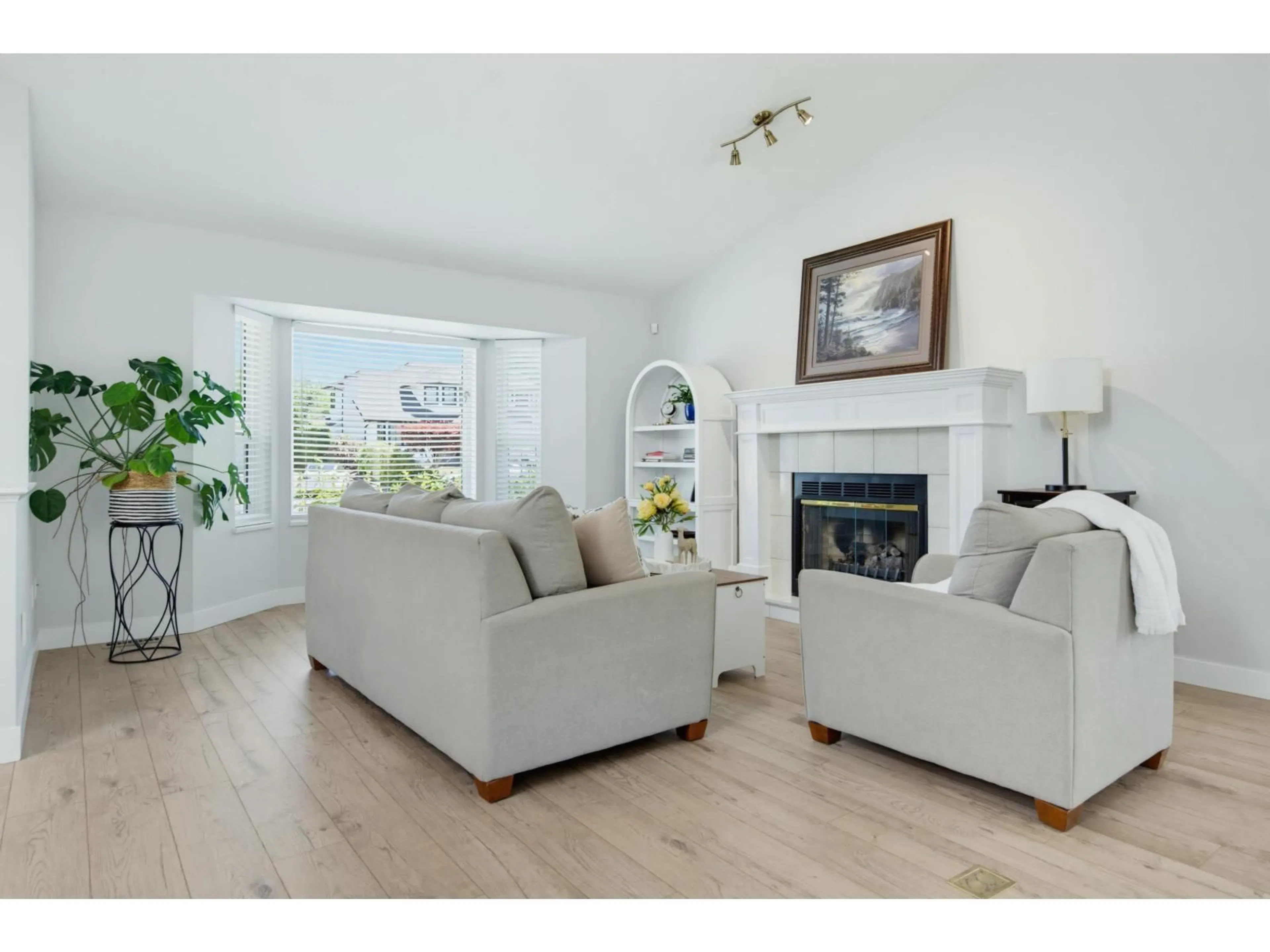 Living room with furniture, wood/laminate floor for 4529 217A STREET, Langley British Columbia V3A8E7