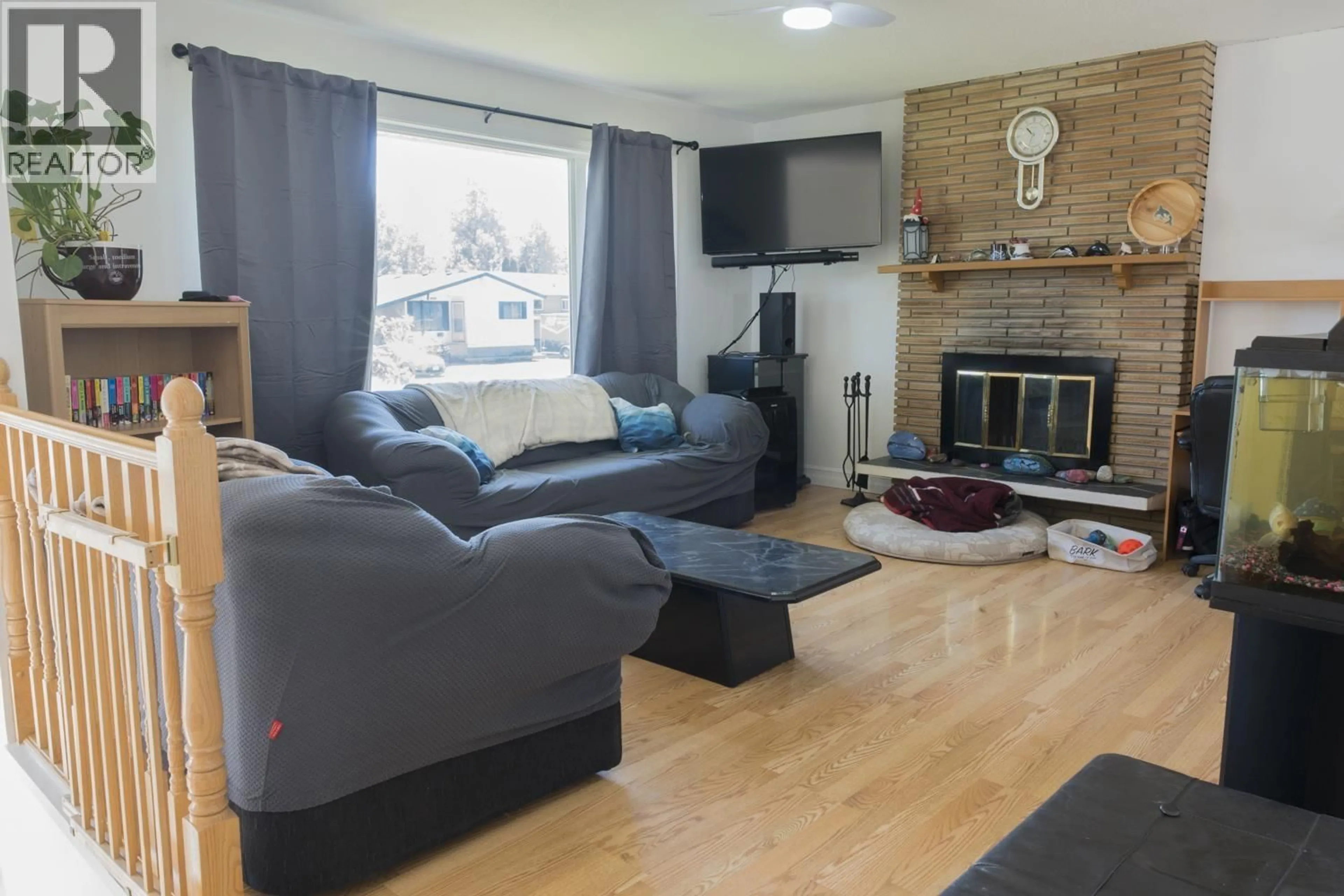 Living room with furniture, wood/laminate floor for 5997 SIMON FRASER AVENUE, Prince George British Columbia V2N2C7
