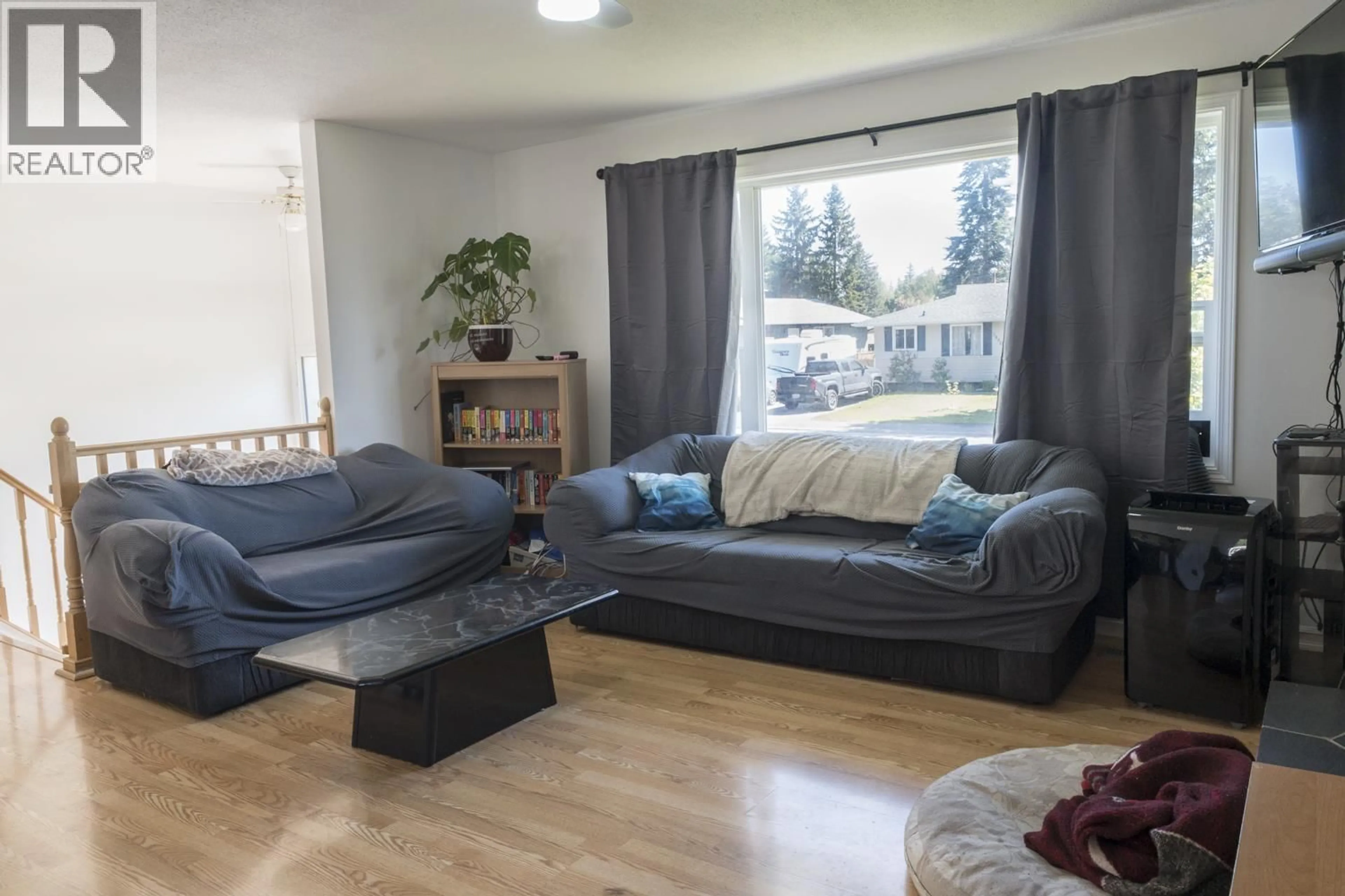 Living room with furniture, wood/laminate floor for 5997 SIMON FRASER AVENUE, Prince George British Columbia V2N2C7