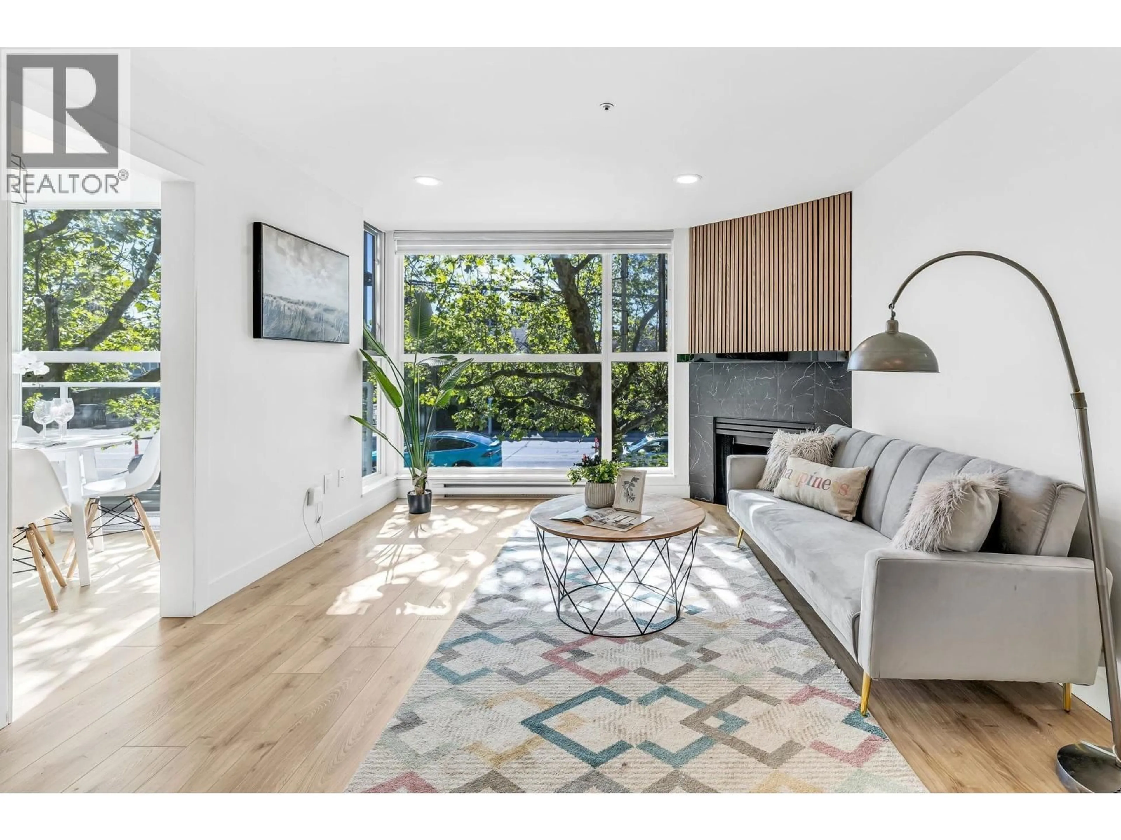 Living room with furniture, wood/laminate floor for 105 - 7700 GILBERT ROAD, Richmond British Columbia V7C3W2