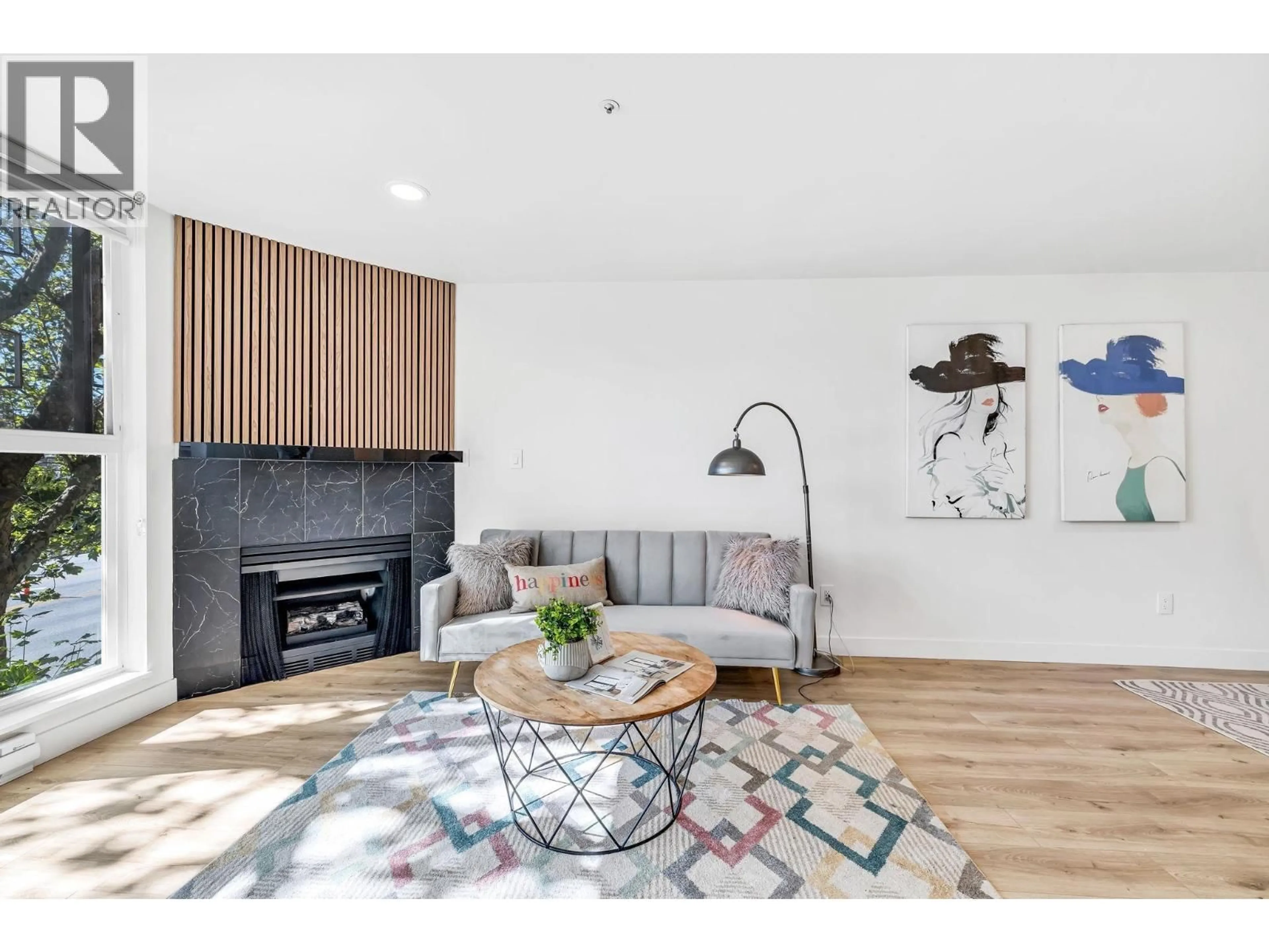 Living room with furniture, wood/laminate floor for 105 - 7700 GILBERT ROAD, Richmond British Columbia V7C3W2