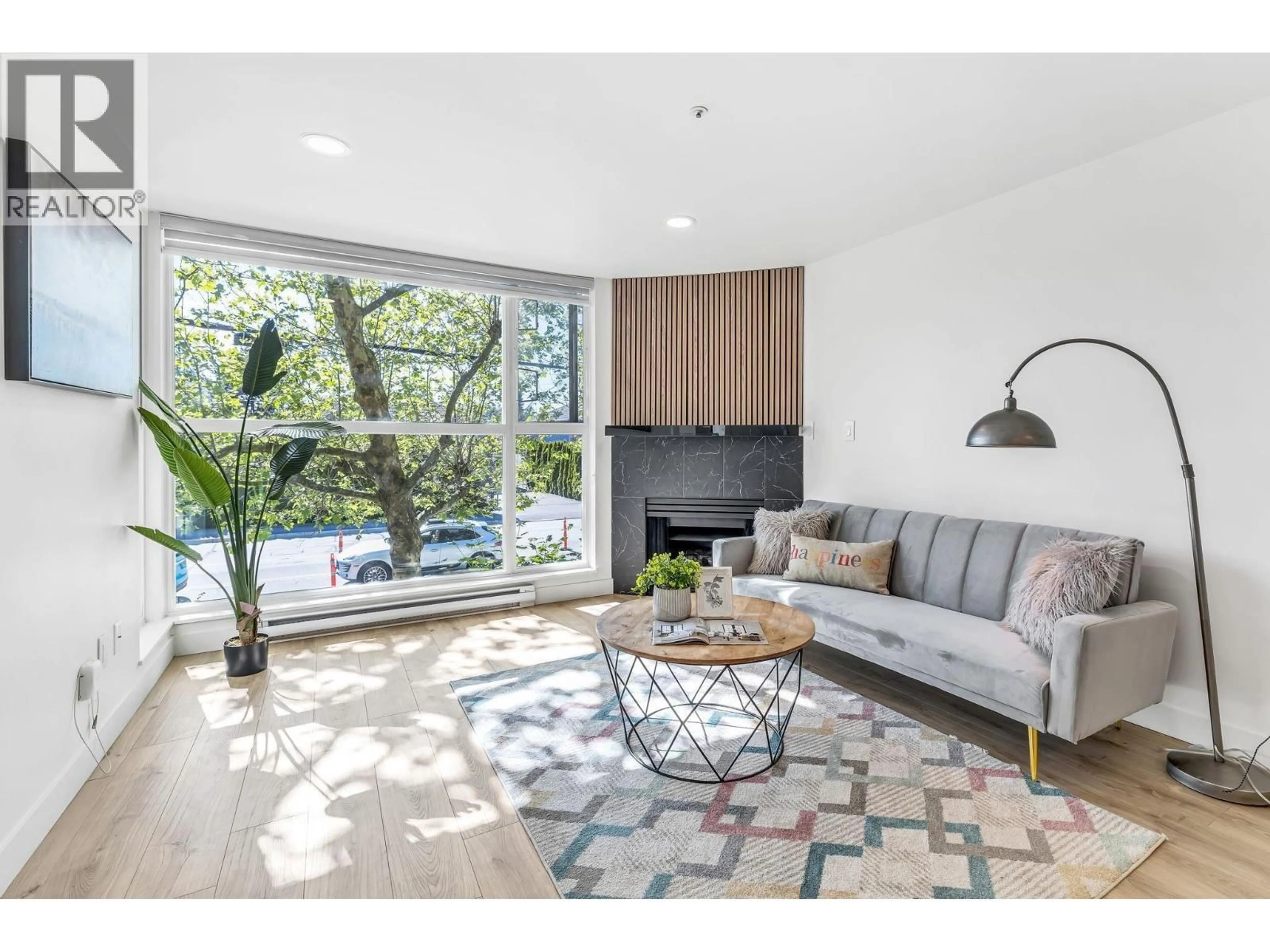 Living room with furniture, wood/laminate floor for 105 - 7700 GILBERT ROAD, Richmond British Columbia V7C3W2