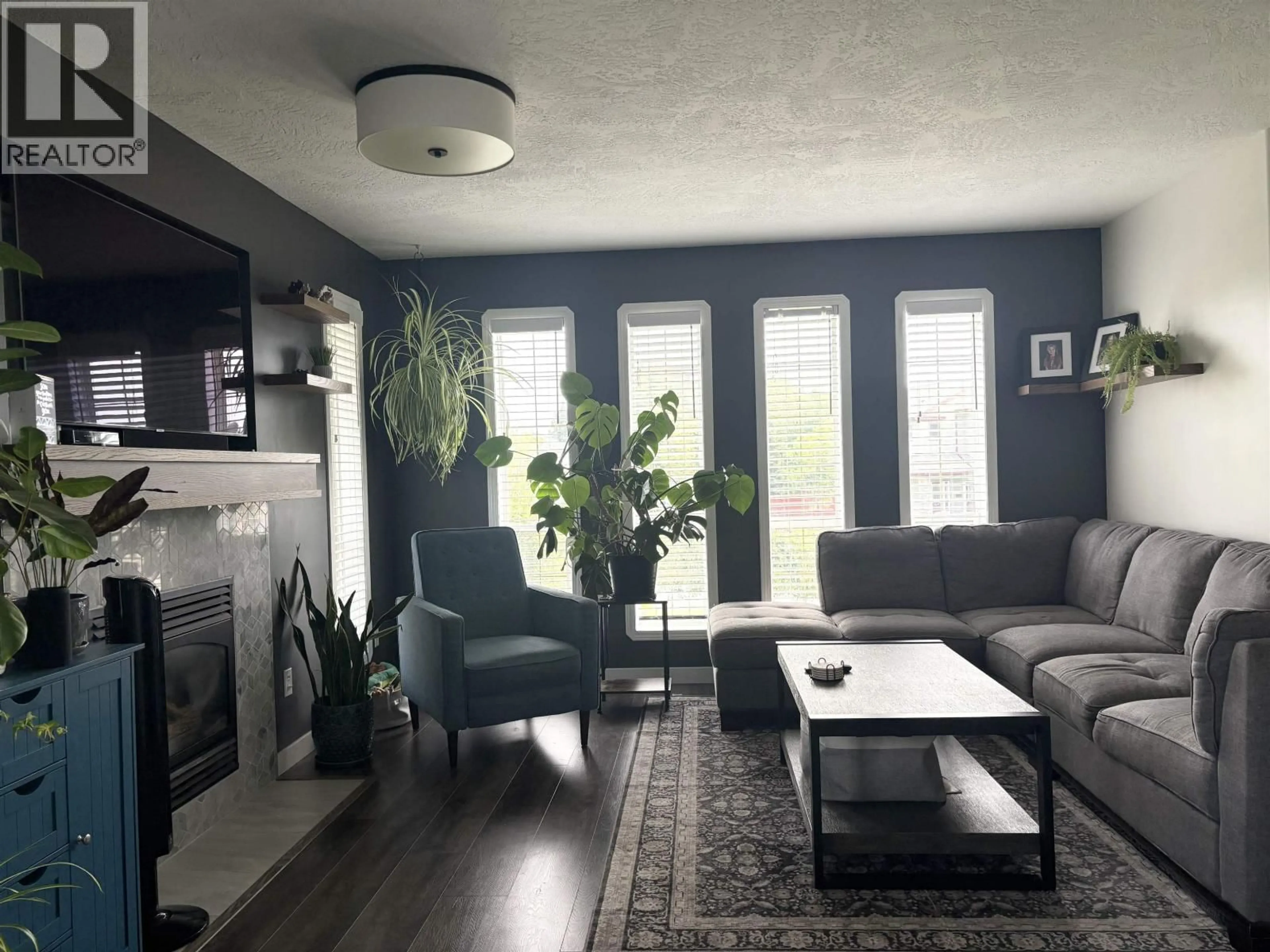 Living room with furniture, wood/laminate floor for 4411 WHEELER ROAD, Prince George British Columbia V2N5H4