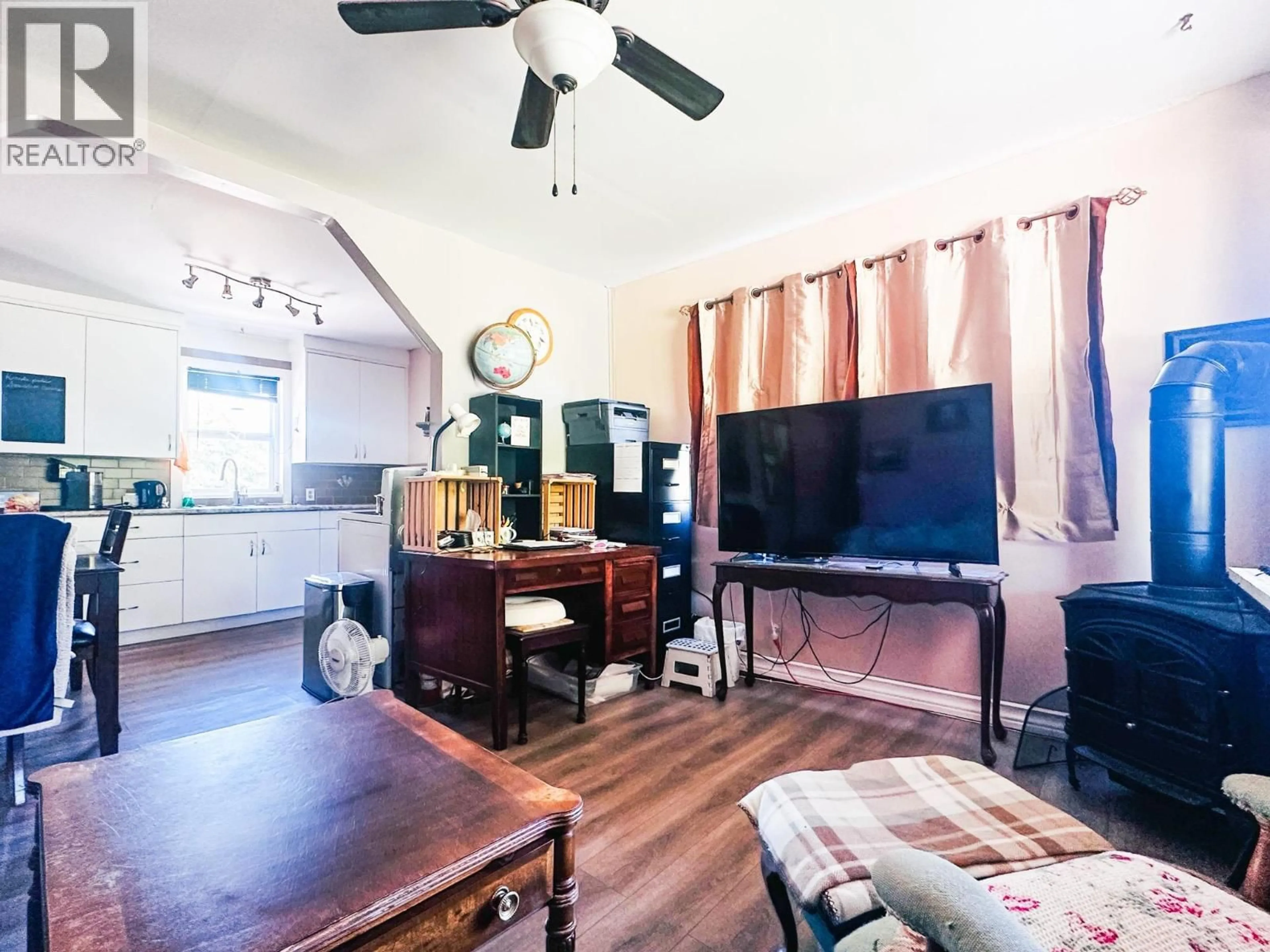 Living room with furniture, wood/laminate floor for 248 PIONEER WAY, Burns Lake British Columbia V0J1E0