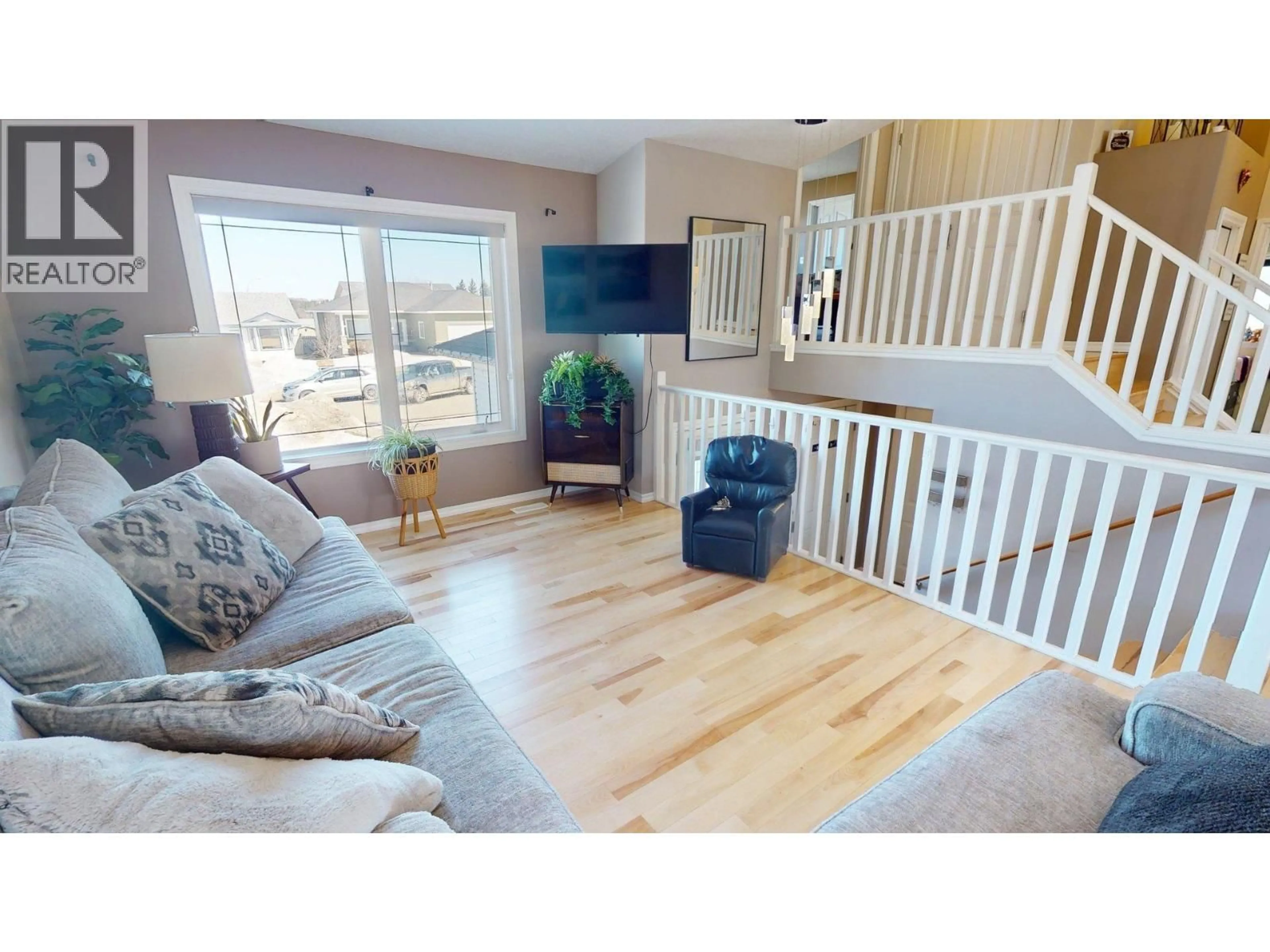 Living room with furniture, wood/laminate floor for 9611 113 AVENUE, Fort St. John British Columbia V1J7J1
