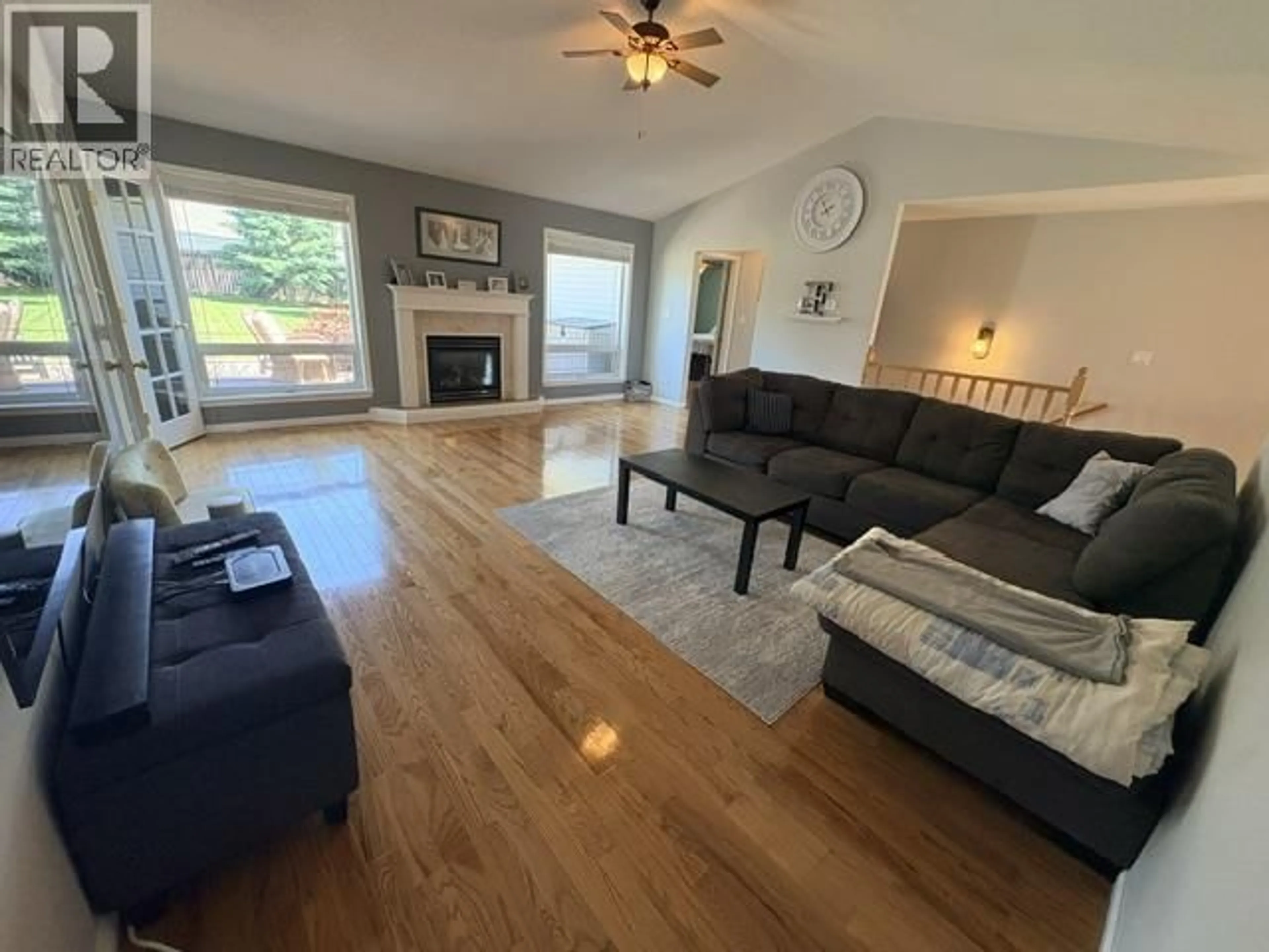 Living room with furniture, wood/laminate floor for 10915 88A STREET, Fort St. John British Columbia V1J7G2