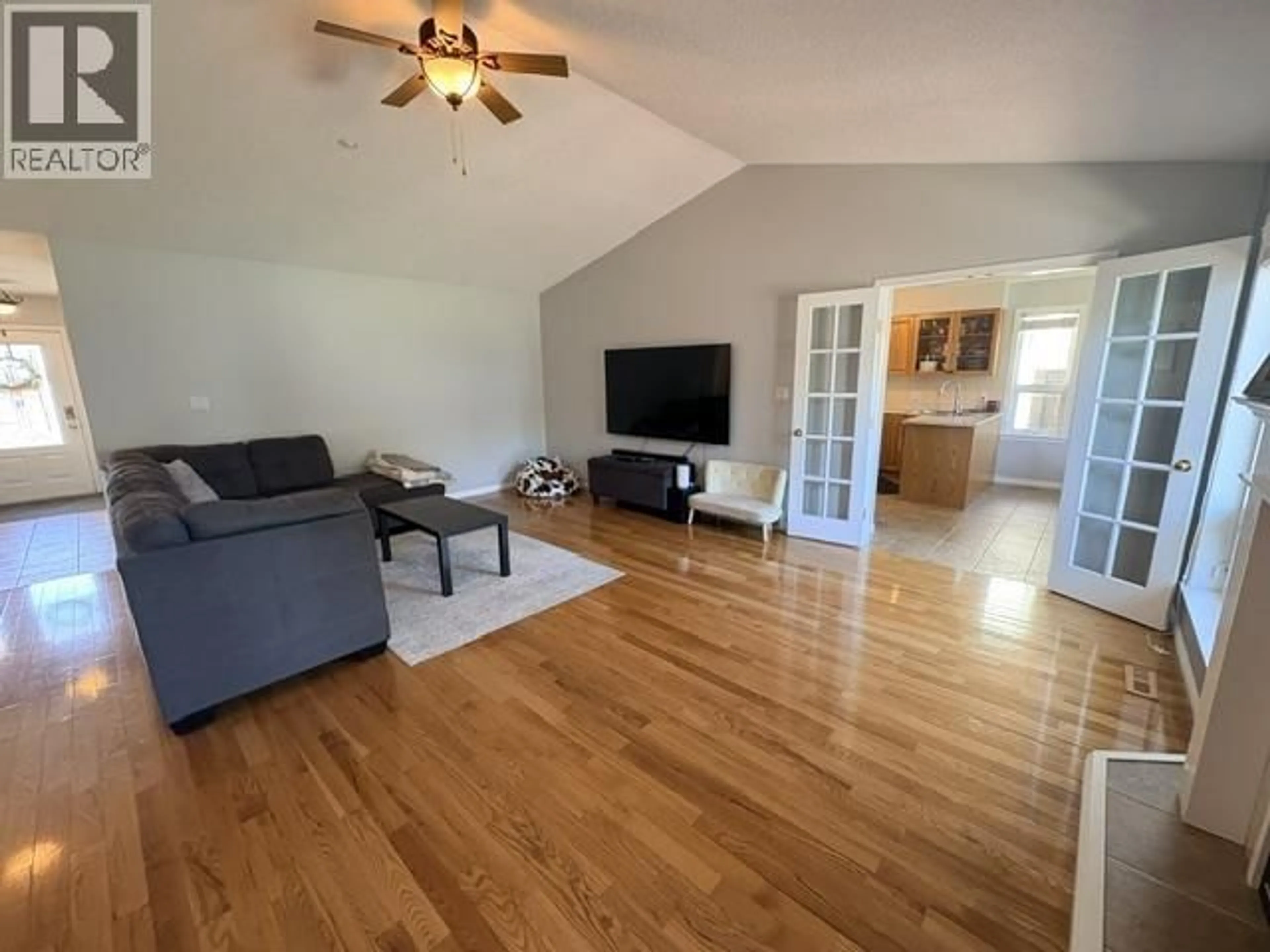 Living room with furniture, wood/laminate floor for 10915 88A STREET, Fort St. John British Columbia V1J7G2