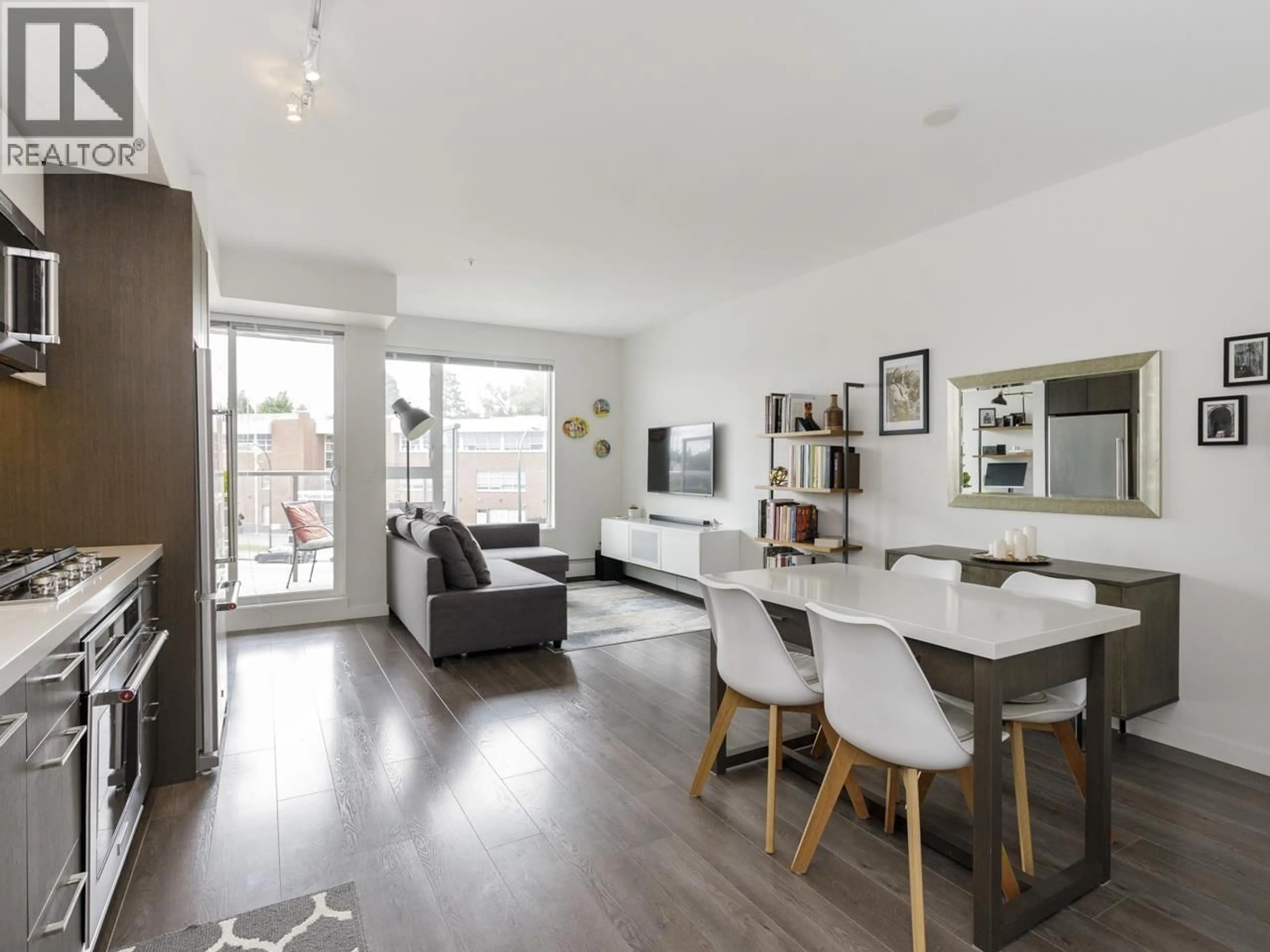 Living room with furniture, wood/laminate floor for 411 - 417 GREAT NORTHERN WAY, Vancouver British Columbia V5T0G7
