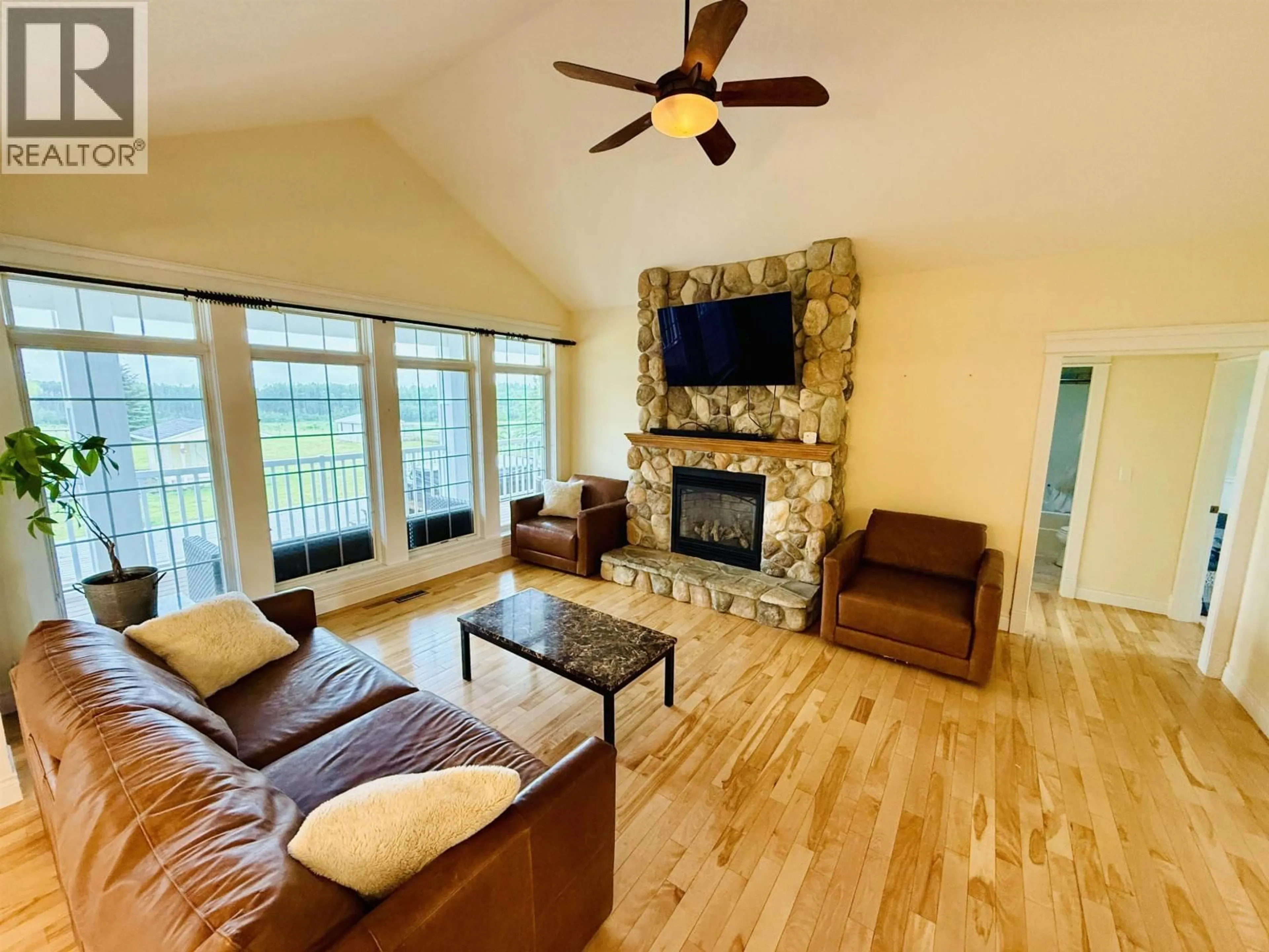 Living room with furniture, wood/laminate floor for 12201 PACIFIC AVENUE, Fort St. John British Columbia V1J8A5