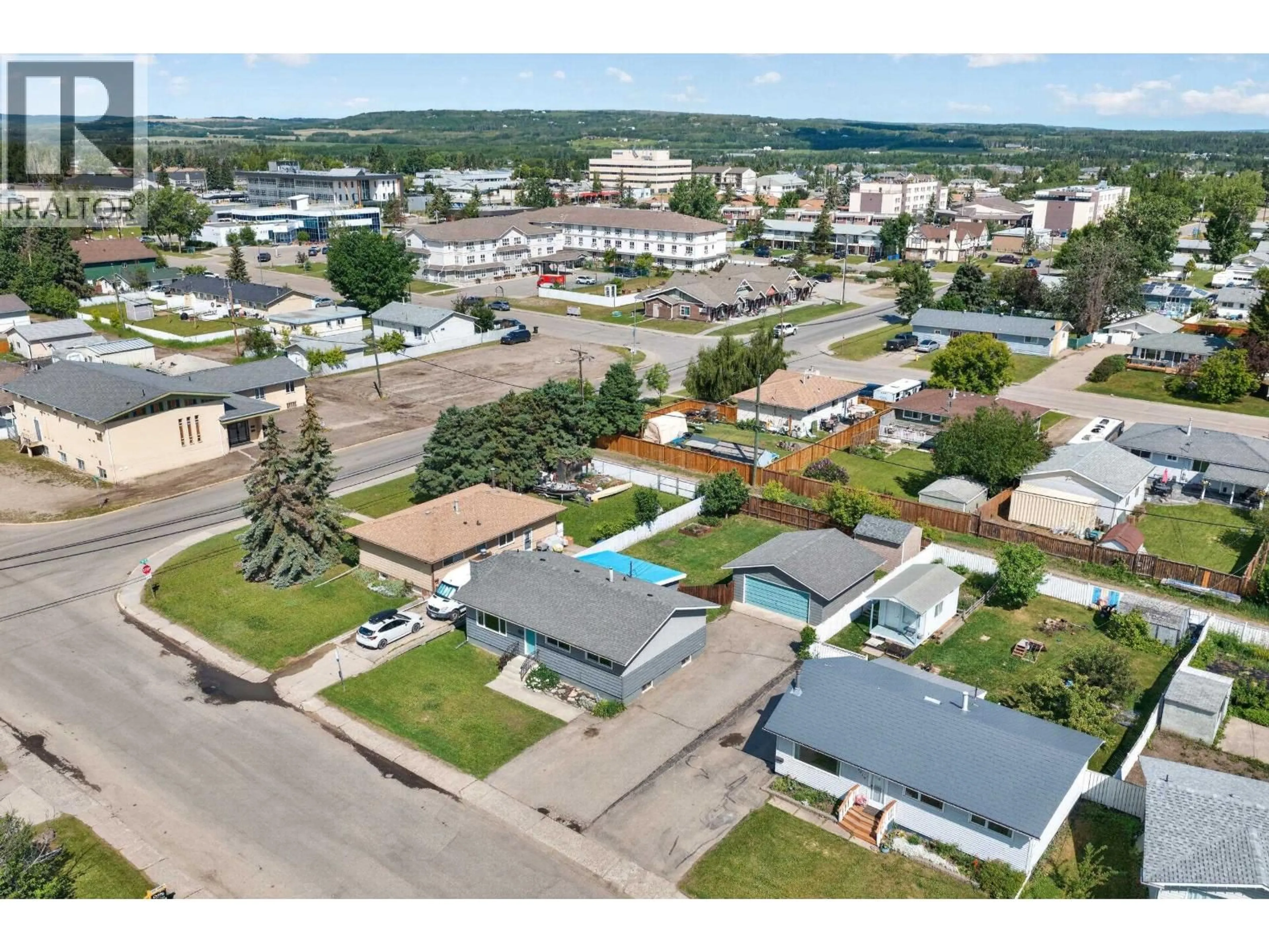 A pic from outside/outdoor area/front of a property/back of a property/a pic from drone, street for 9720 105 AVENUE, Fort St. John British Columbia V1J2M1