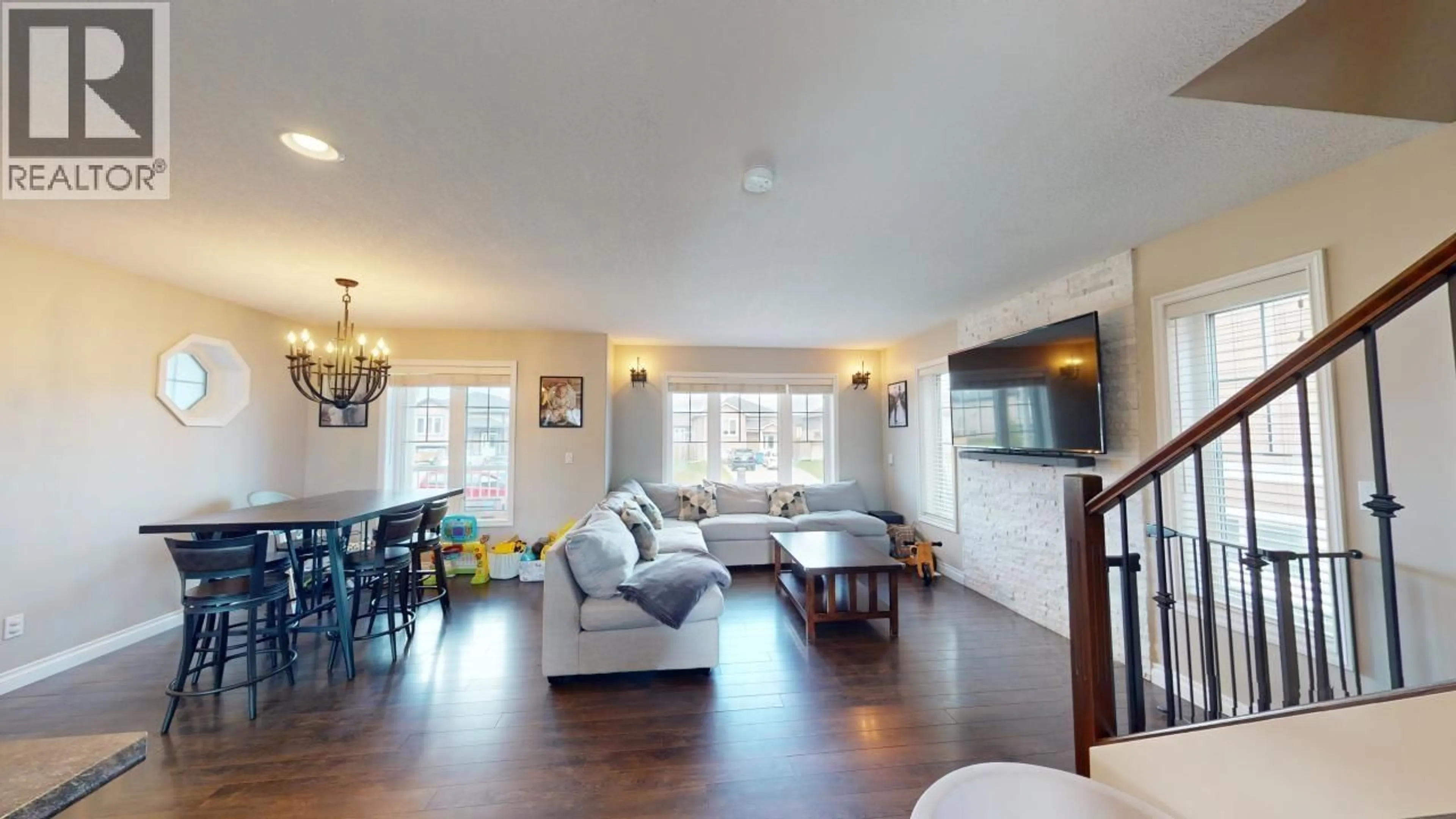Living room with furniture, wood/laminate floor for 8711 113 AVENUE, Fort St. John British Columbia V1J0E2