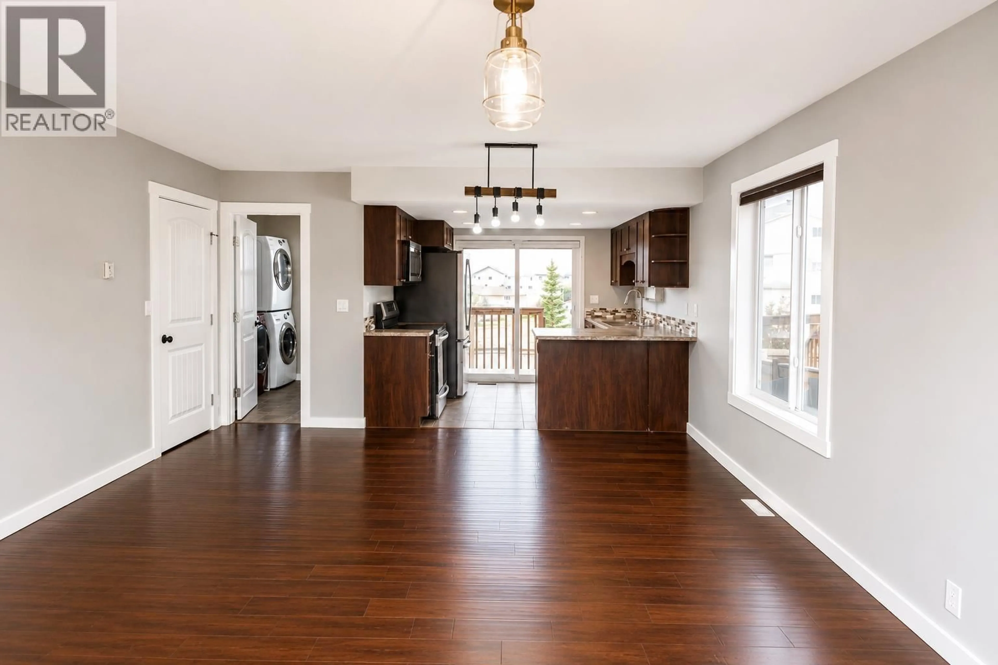 Open concept kitchen, wood/laminate floor for 8506 85 STREET, Fort St. John British Columbia V1J0G5
