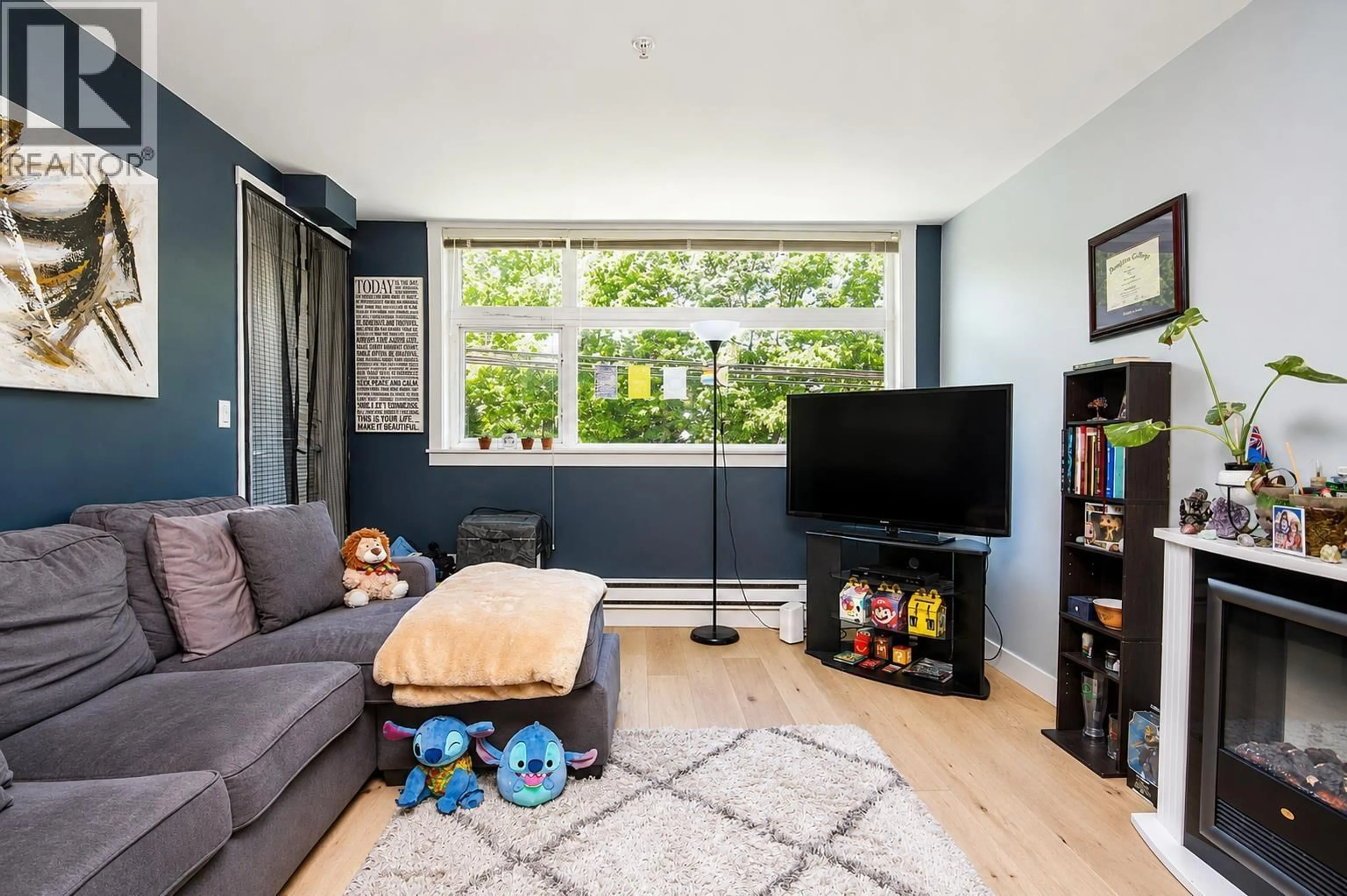Living room with furniture, wood/laminate floor for 205 - 5488 CECIL STREET, Vancouver British Columbia V5R4E5