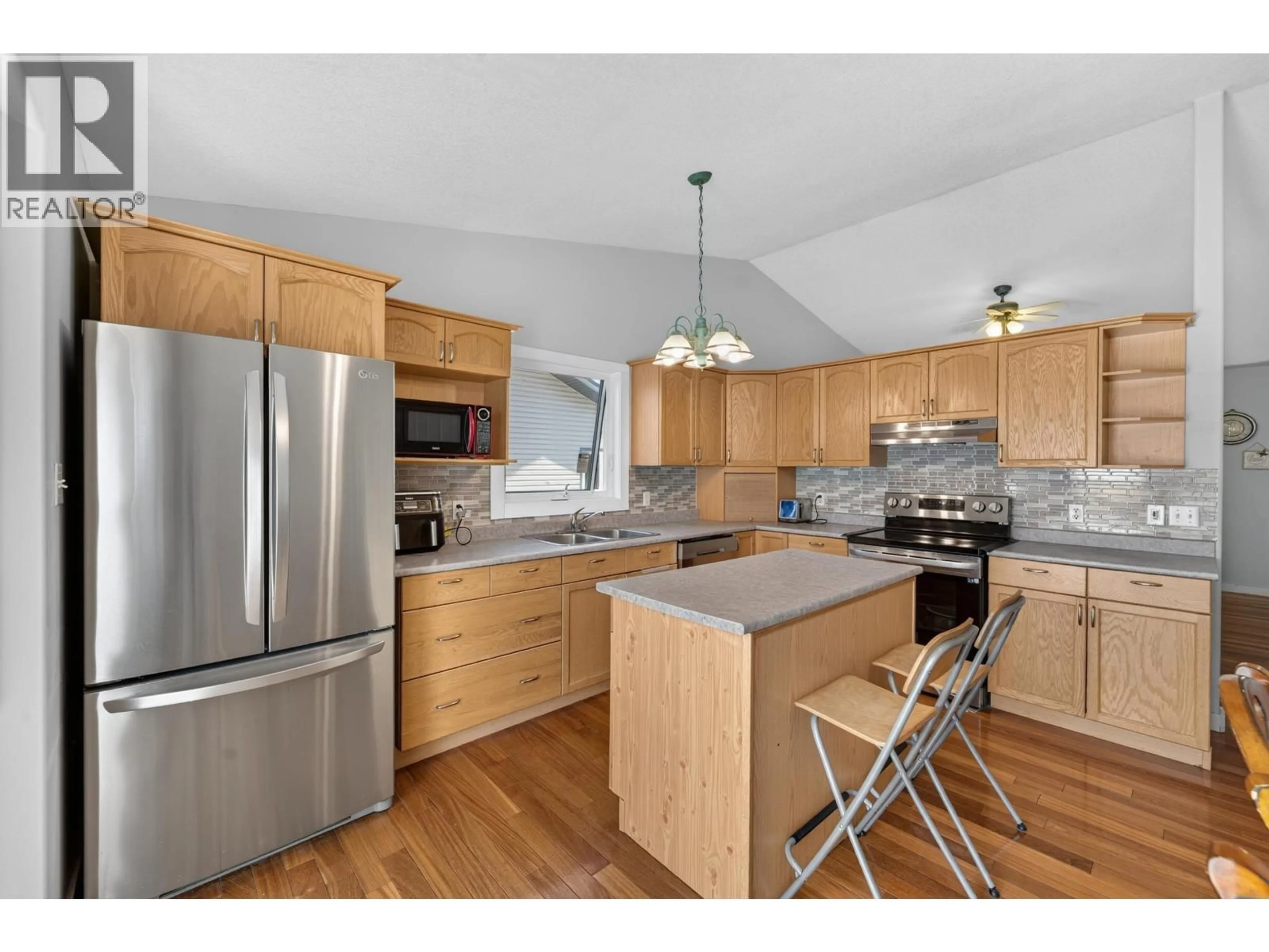 Open concept kitchen, wood/laminate floor for 9007 112 AVENUE, Fort St. John British Columbia V1J6G2