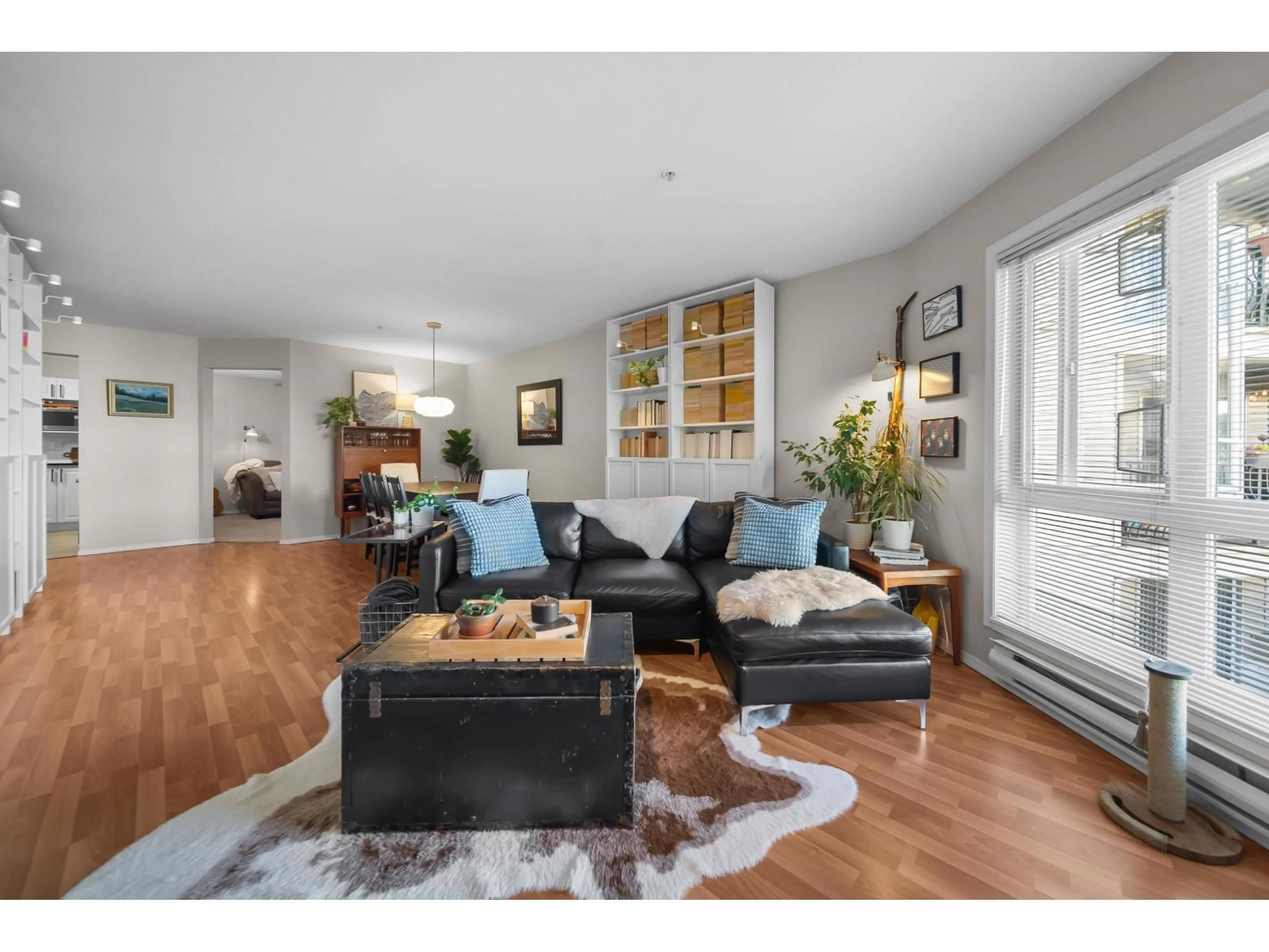 Living room with furniture, wood/laminate floor for 206 - 3172 GLADWIN ROAD, Abbotsford British Columbia V2T5T3