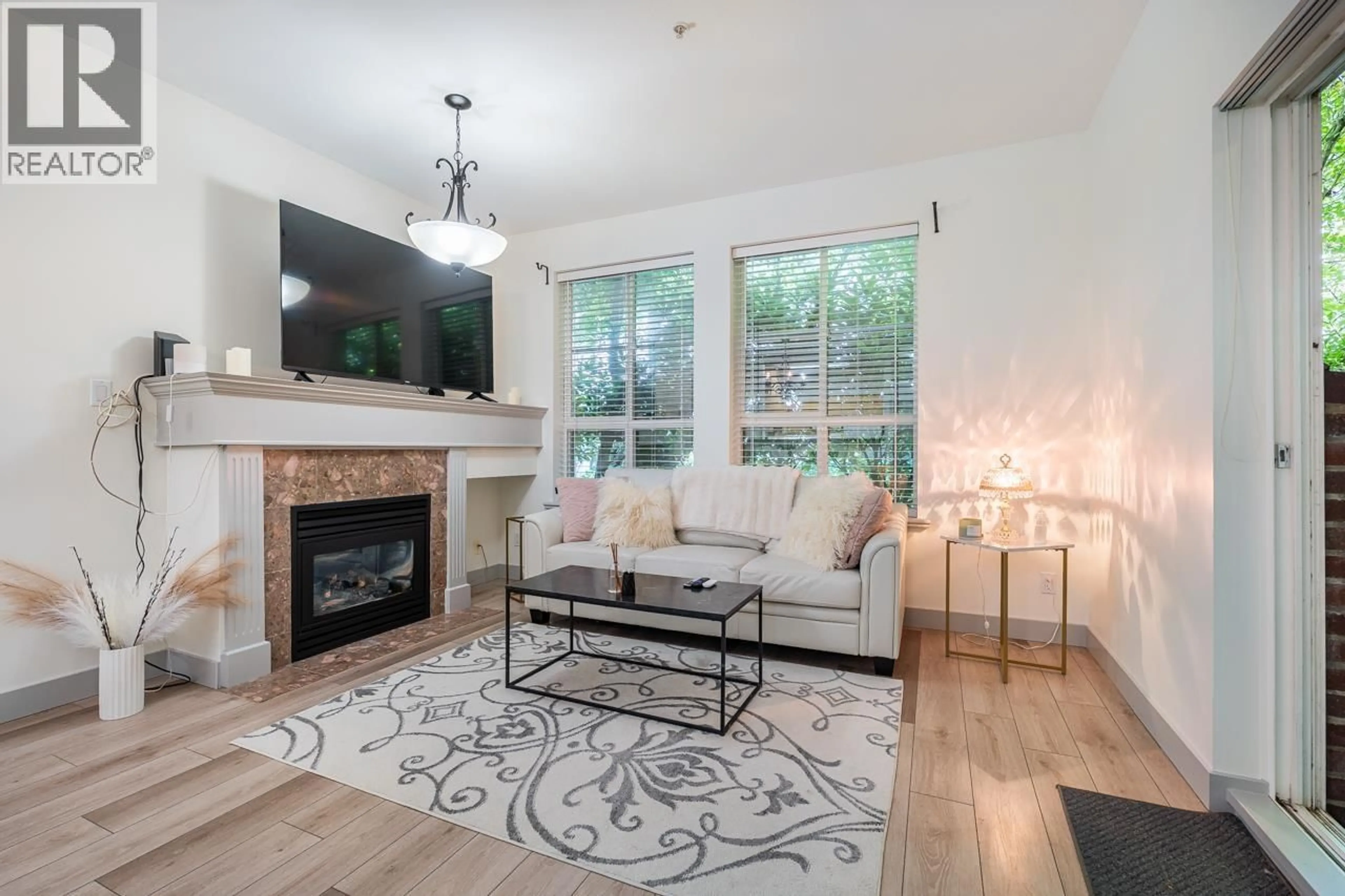 Living room with furniture, wood/laminate floor for 104 - 522 SMITH AVENUE, Coquitlam British Columbia V3J7X7