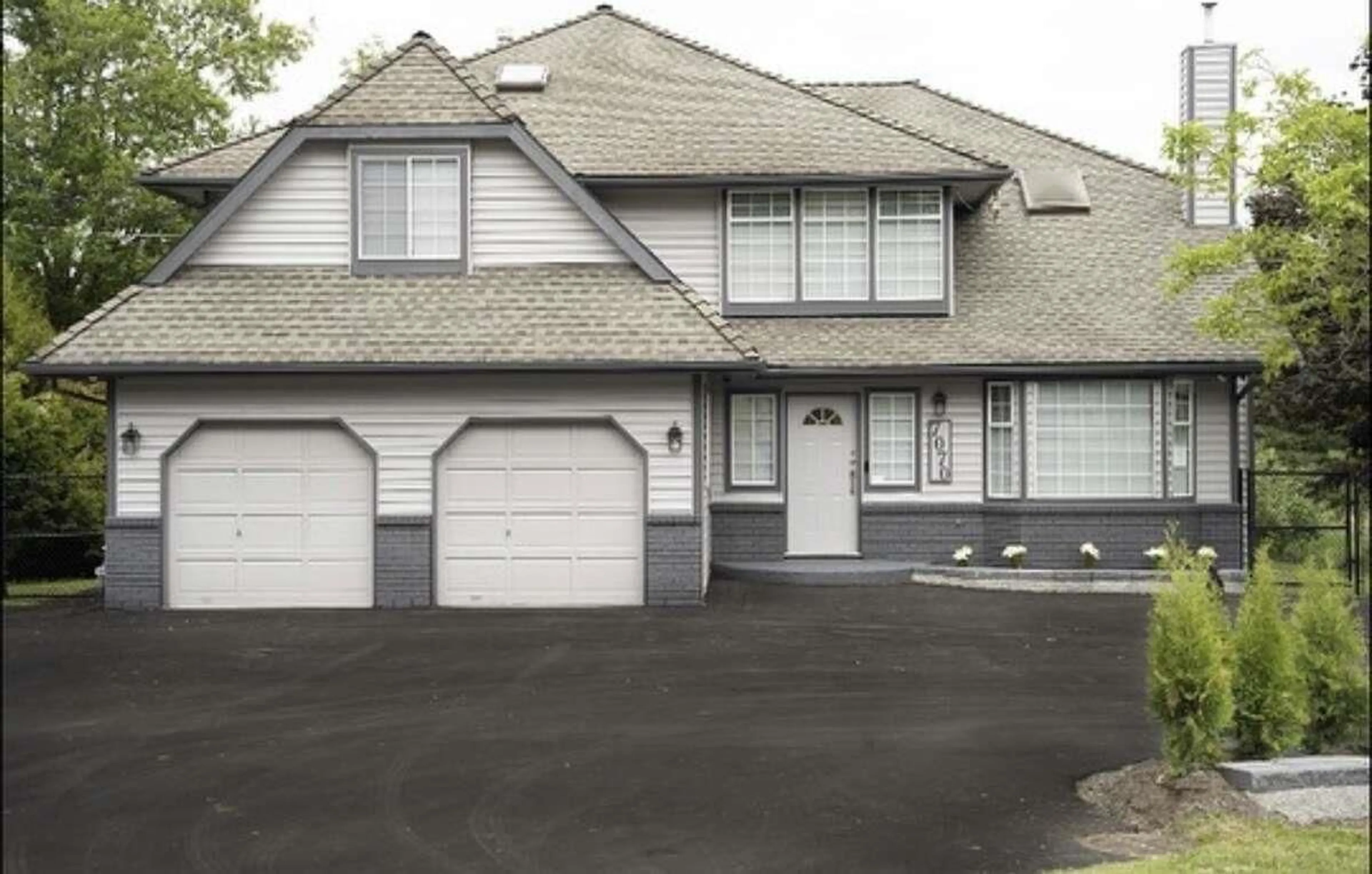 Home with vinyl exterior material, street for 7070 207 STREET, Langley British Columbia V2Y1T4