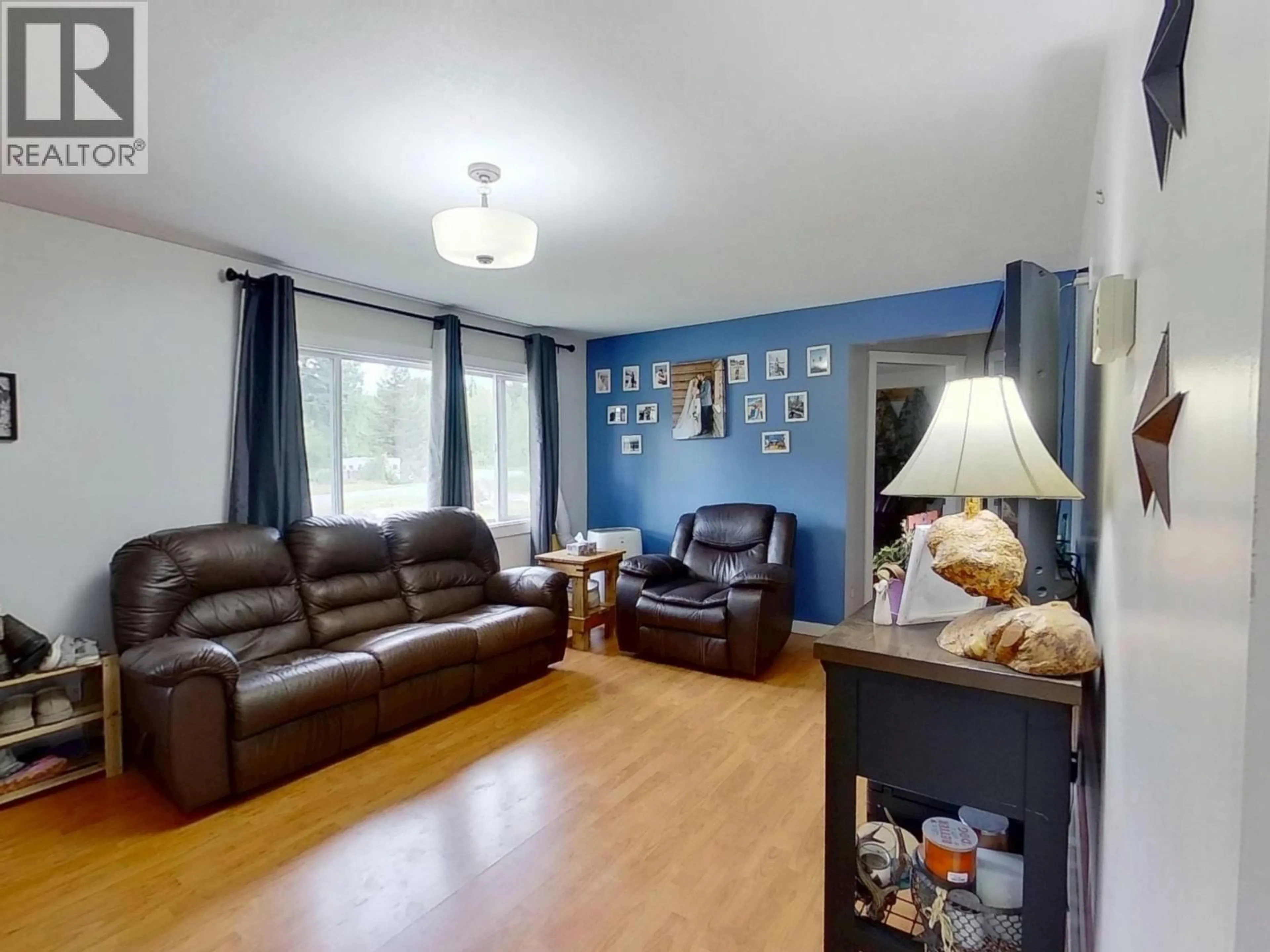 Living room with furniture, wood/laminate floor for 2403 NORWOOD ROAD, Quesnel British Columbia V2J7G7
