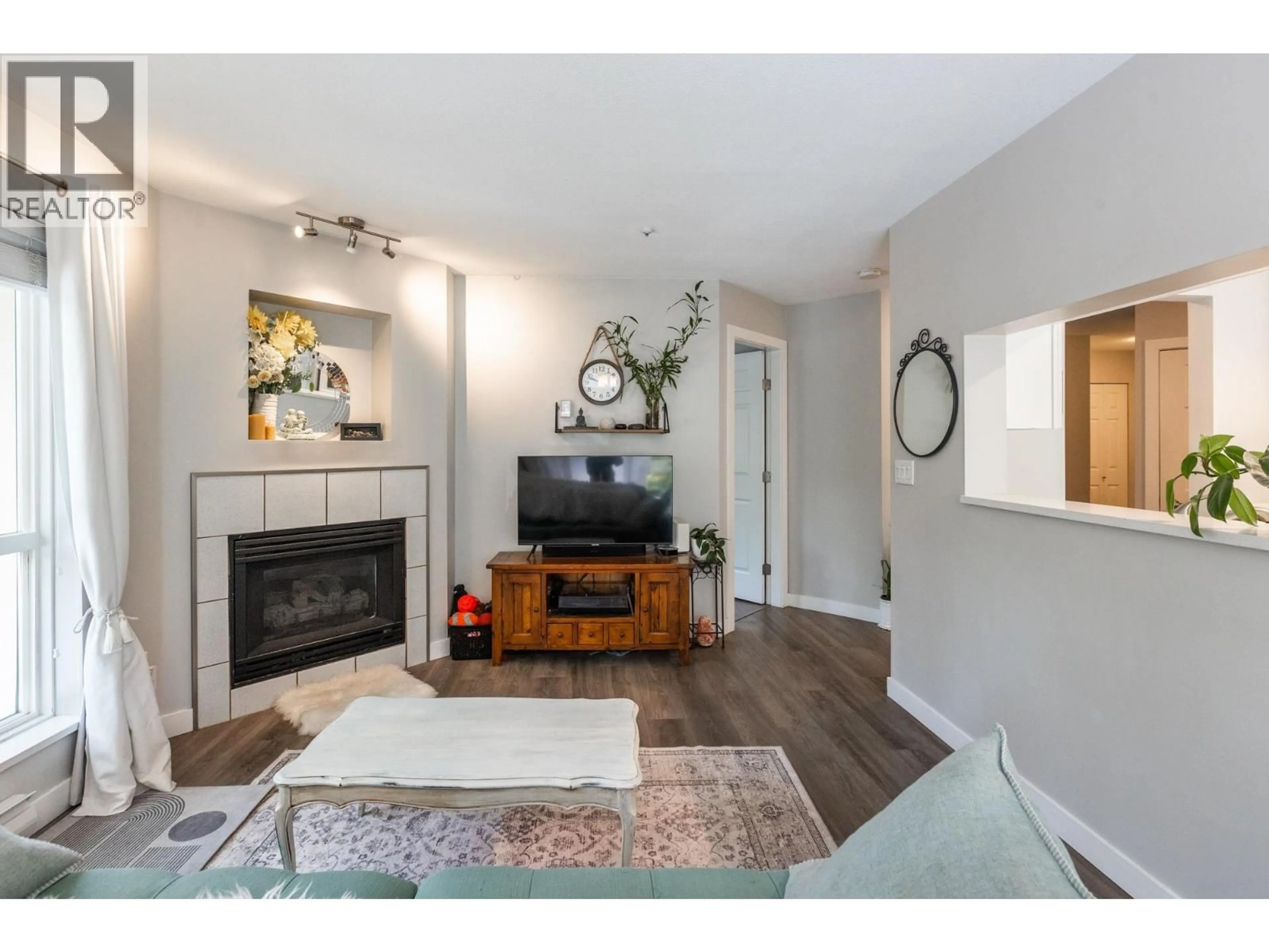 Living room with furniture, wood/laminate floor for 209 - 2437 WELCHER AVENUE, Port Coquitlam British Columbia V3C1X8