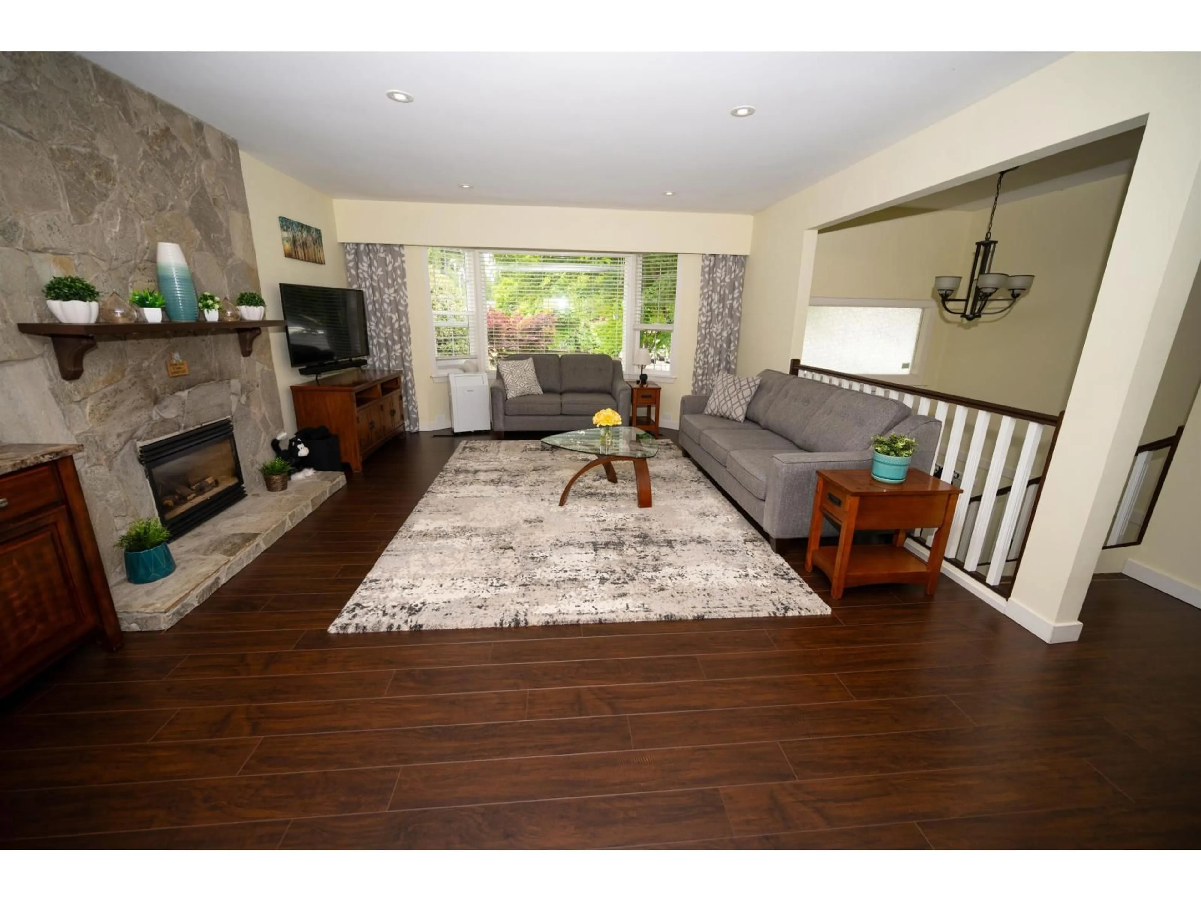 Living room with furniture, wood/laminate floor for 4536 199A STREET, Langley British Columbia V3A5S3