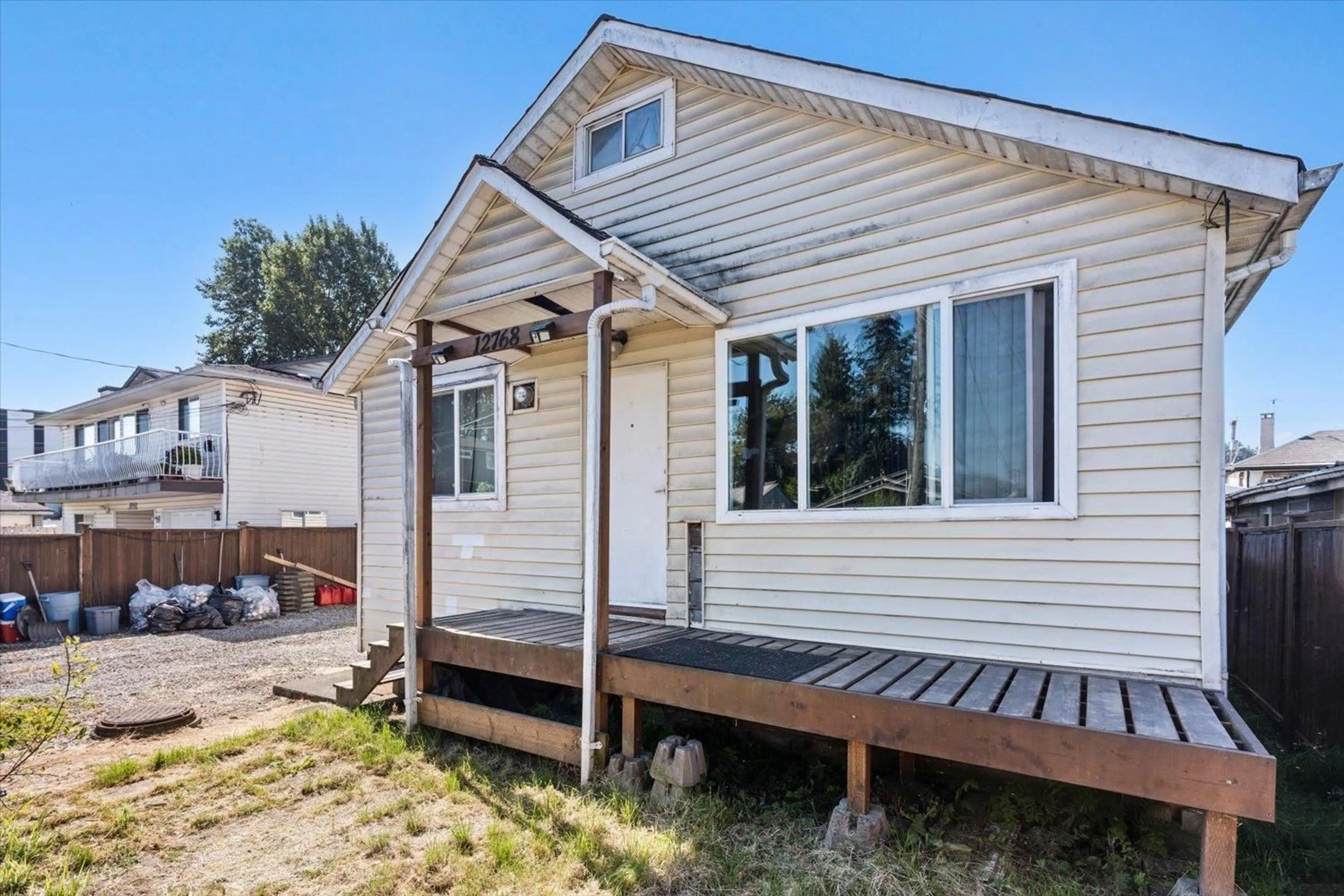 Home with vinyl exterior material, street for 12768 112B AVENUE, Surrey British Columbia V3V3L6