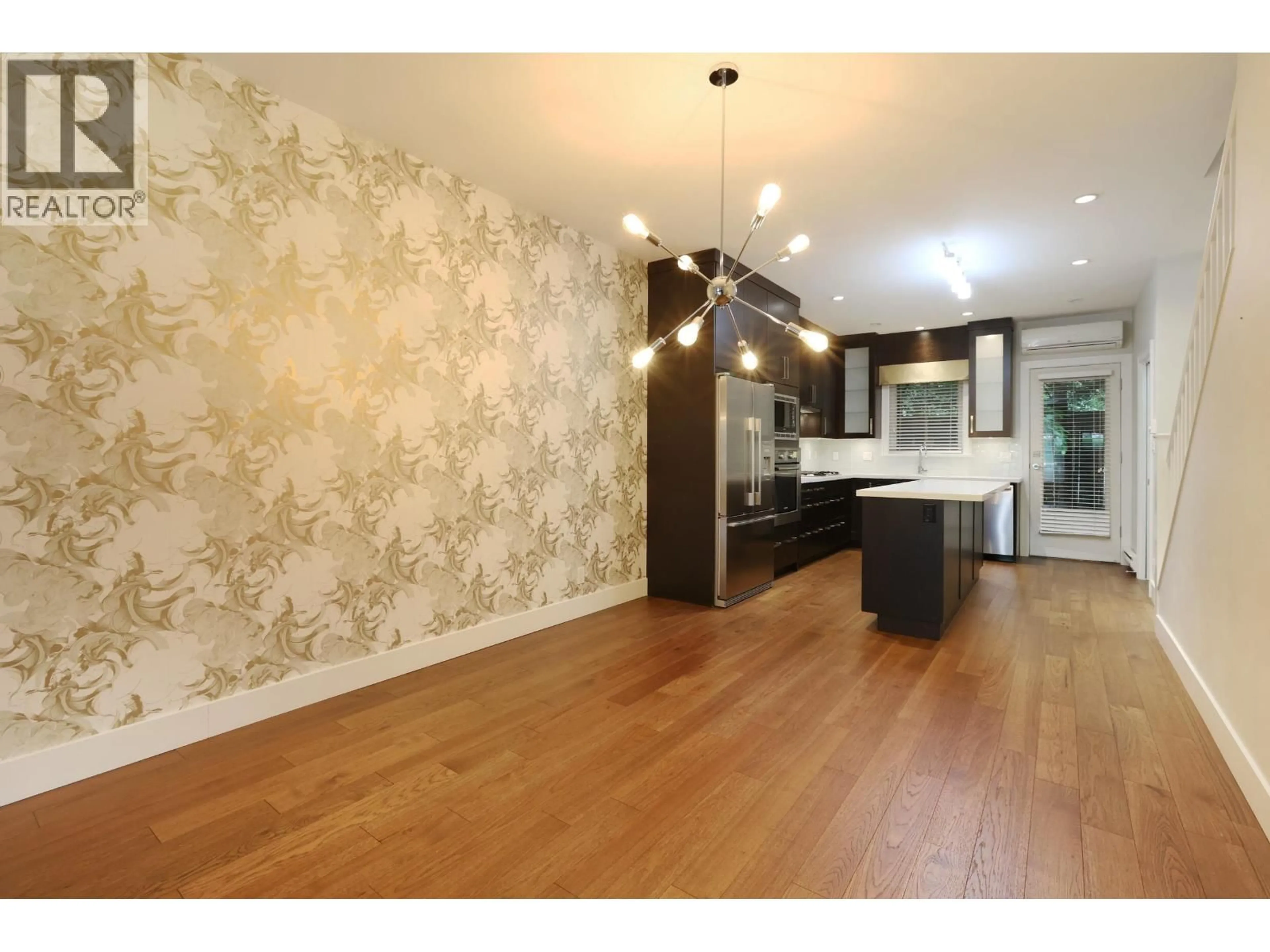 Open concept kitchen, wood/laminate floor for 1459 TILNEY MEWS, Vancouver British Columbia V6P0B1