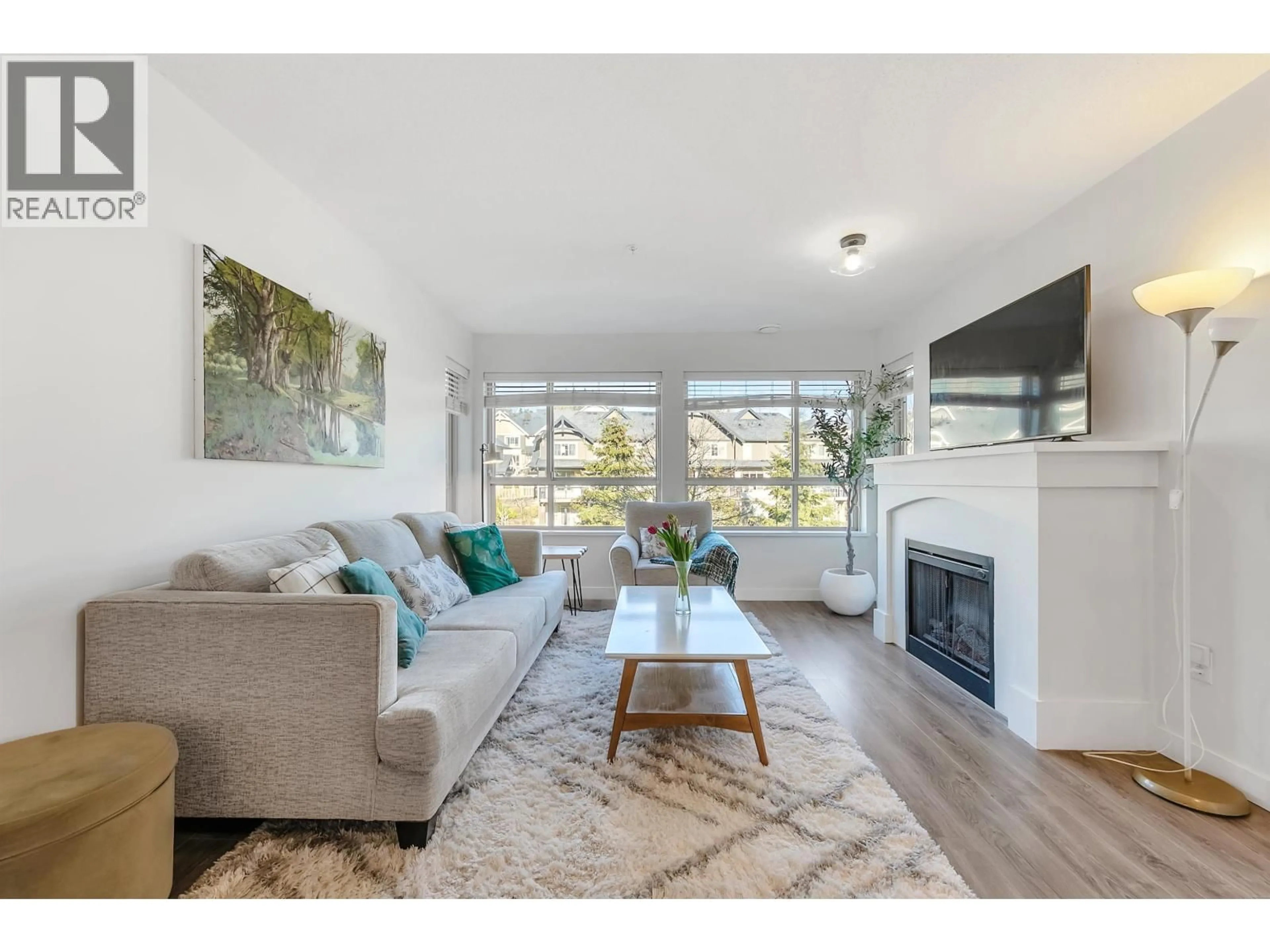 Living room with furniture, wood/laminate floor for 401 - 3132 DAYANEE SPRINGS BOULEVARD, Coquitlam British Columbia V3E0B5