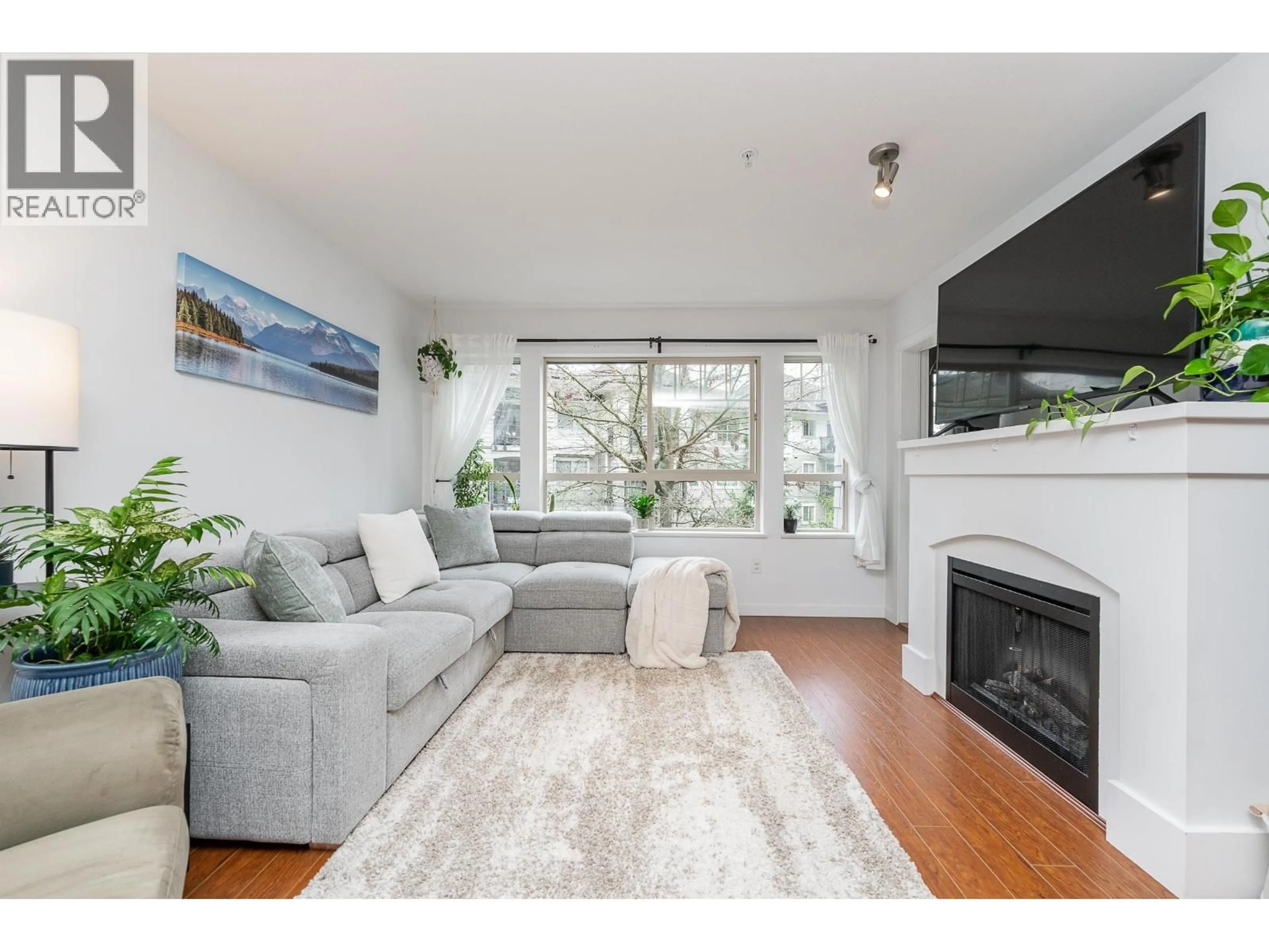 Living room with furniture, wood/laminate floor for 201 - 2951 SILVER SPRINGS BOULEVARD, Coquitlam British Columbia V3E3S4