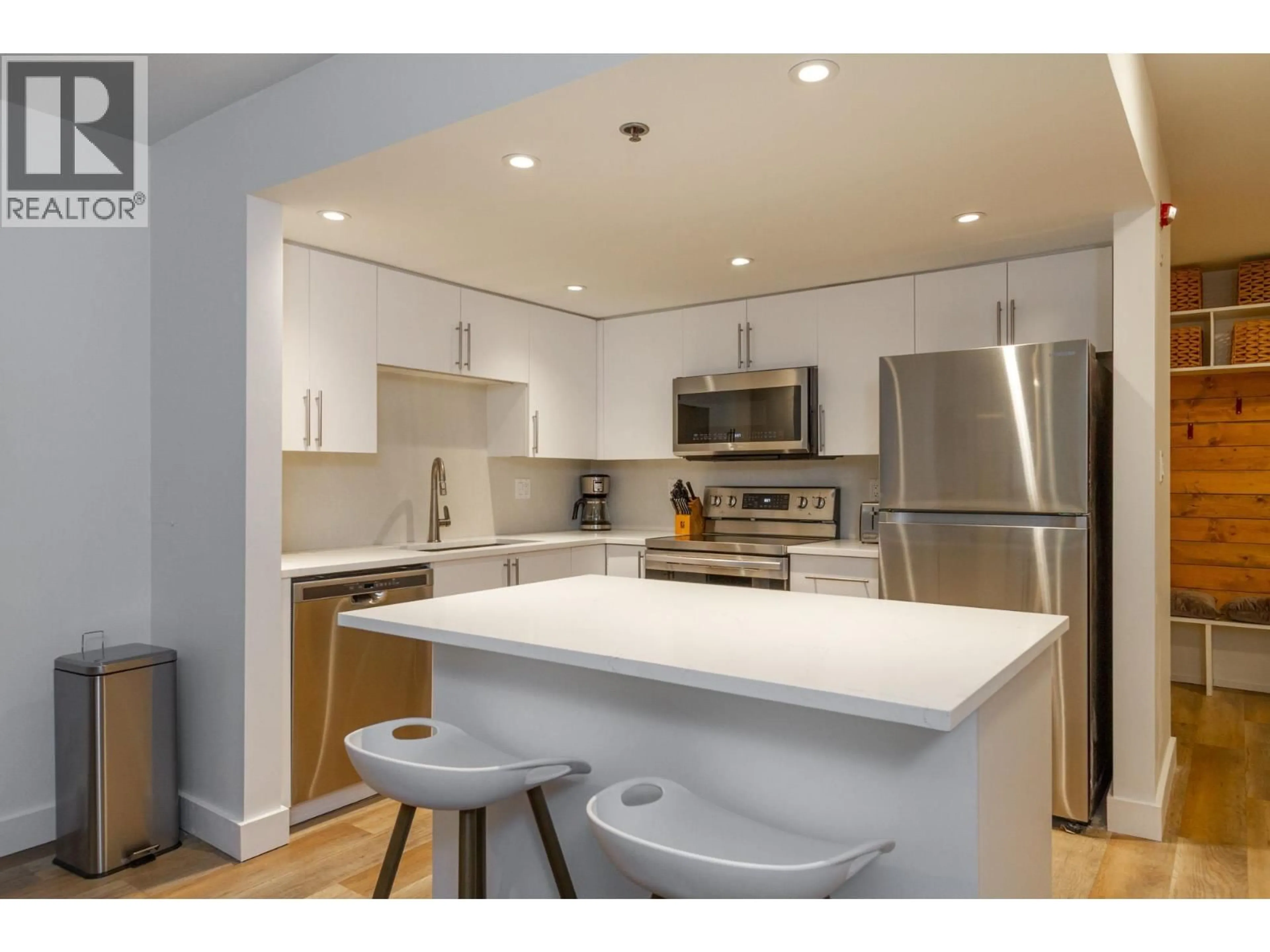 Open concept kitchen, wood/laminate floor for 122 - 3309 PTARMIGAN PLACE, Whistler British Columbia V8E0V6