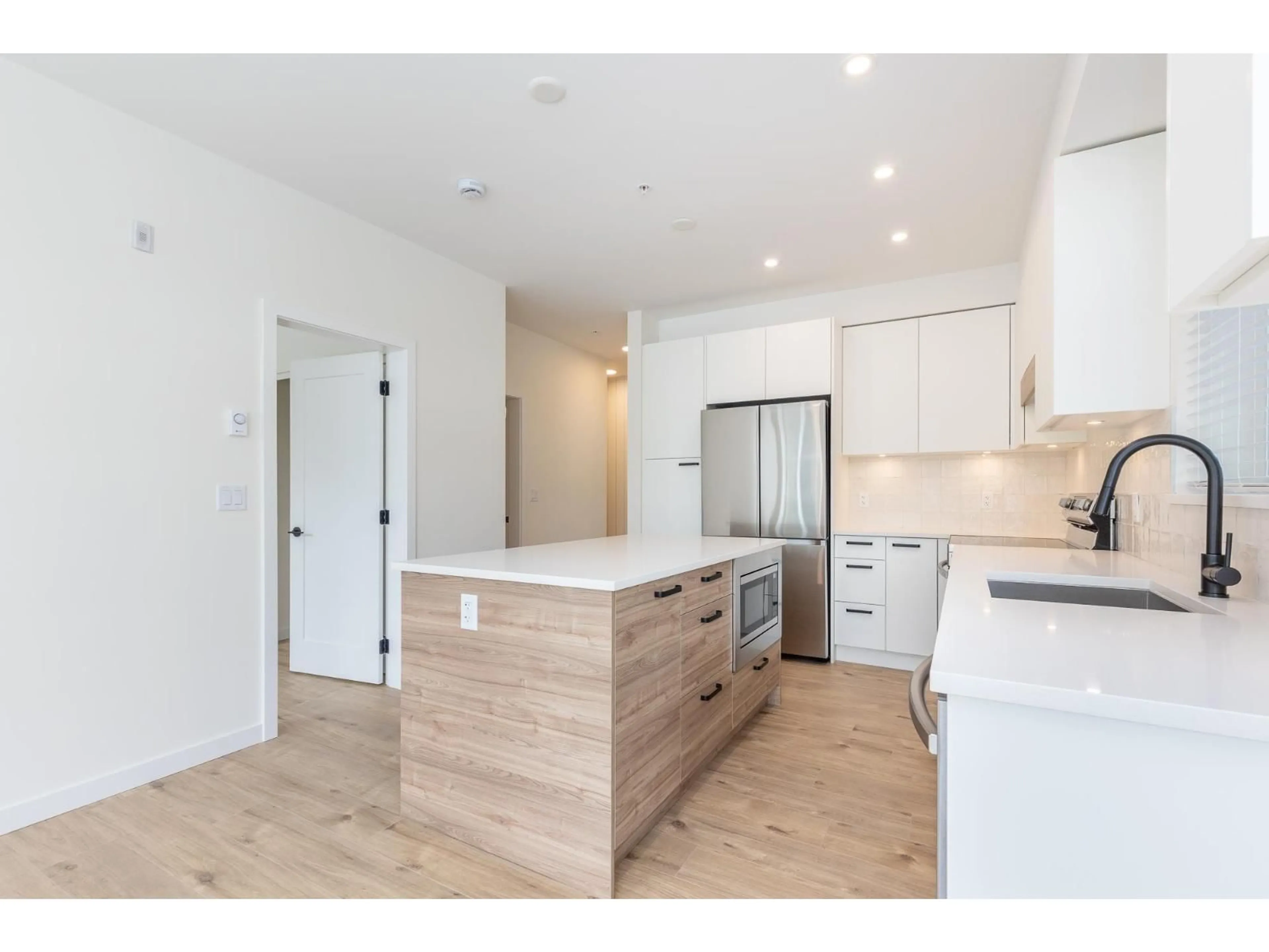 Open concept kitchen, wood/laminate floor for 112 - 33920 BEST AVENUE, Mission British Columbia V2V0L9