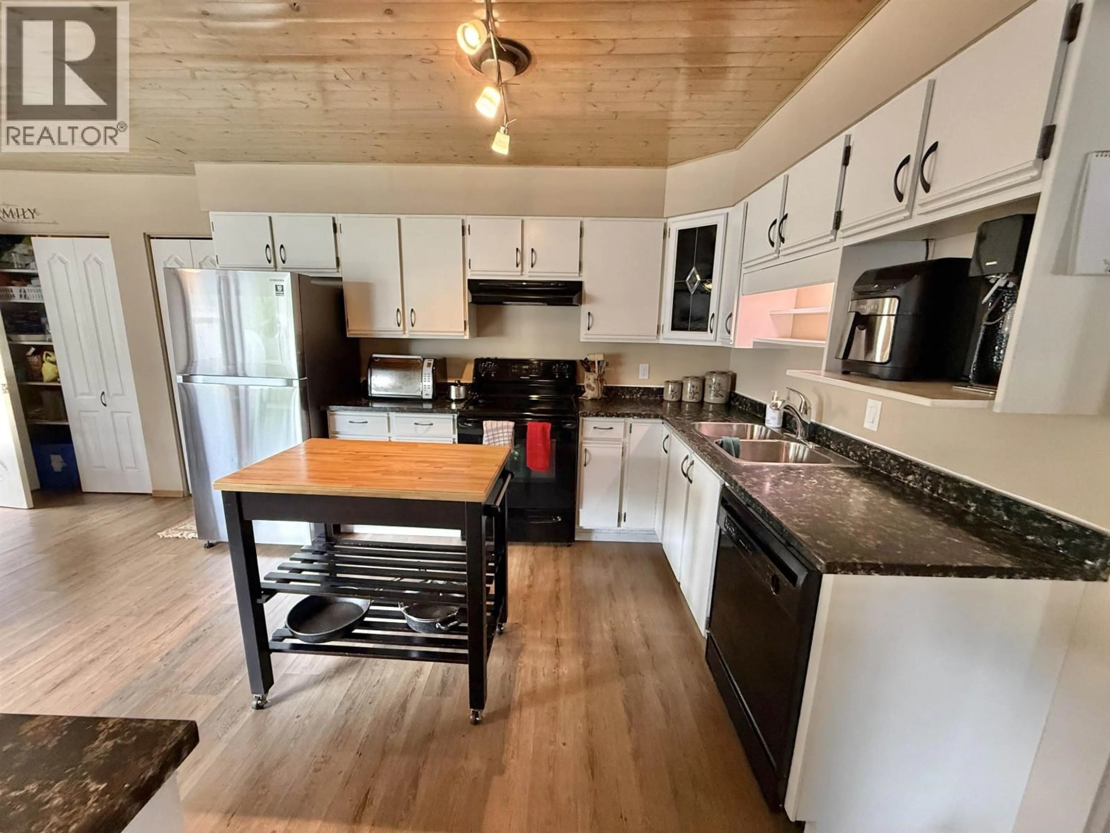 Open concept kitchen, wood/laminate floor for 121 SARGENT STREET, Quesnel British Columbia V2J3G1