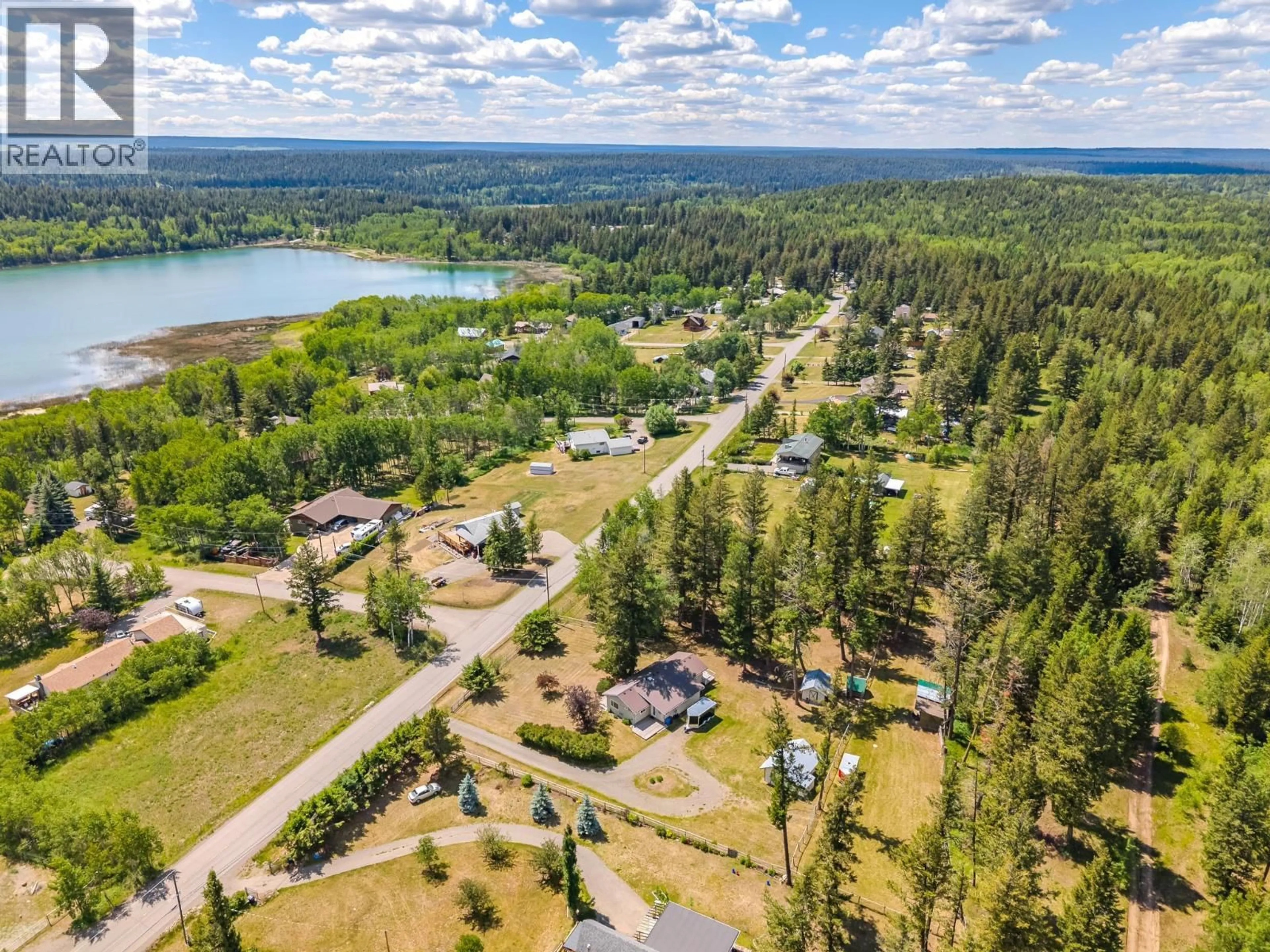 A pic from outside/outdoor area/front of a property/back of a property/a pic from drone, water/lake/river/ocean view for 4734 KITWANGA DRIVE, 108 Mile Ranch British Columbia V0K2Z0