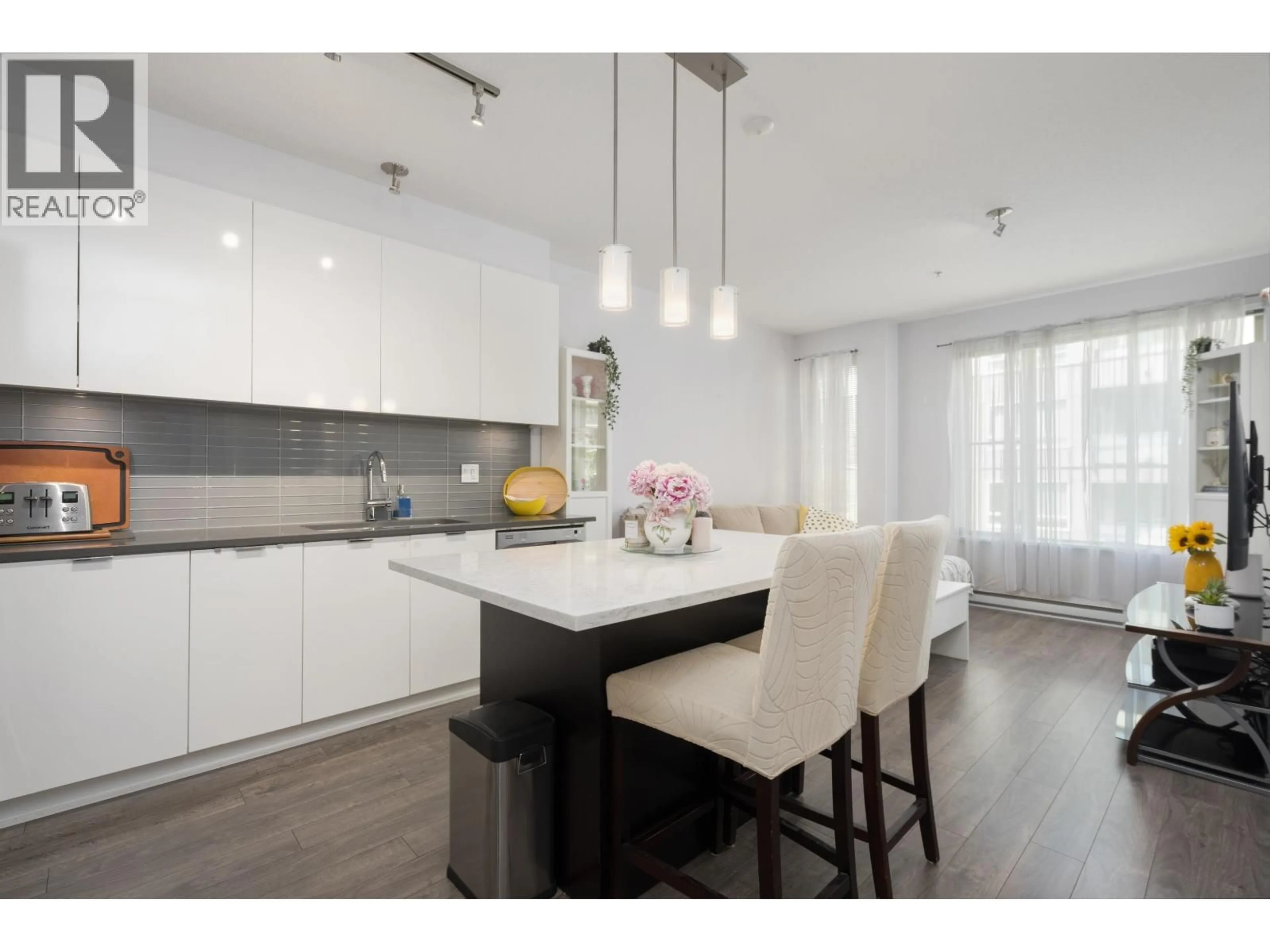 Open concept kitchen, wood/laminate floor for 417 - 2665 MOUNTAIN HIGHWAY, North Vancouver British Columbia V7J0A8