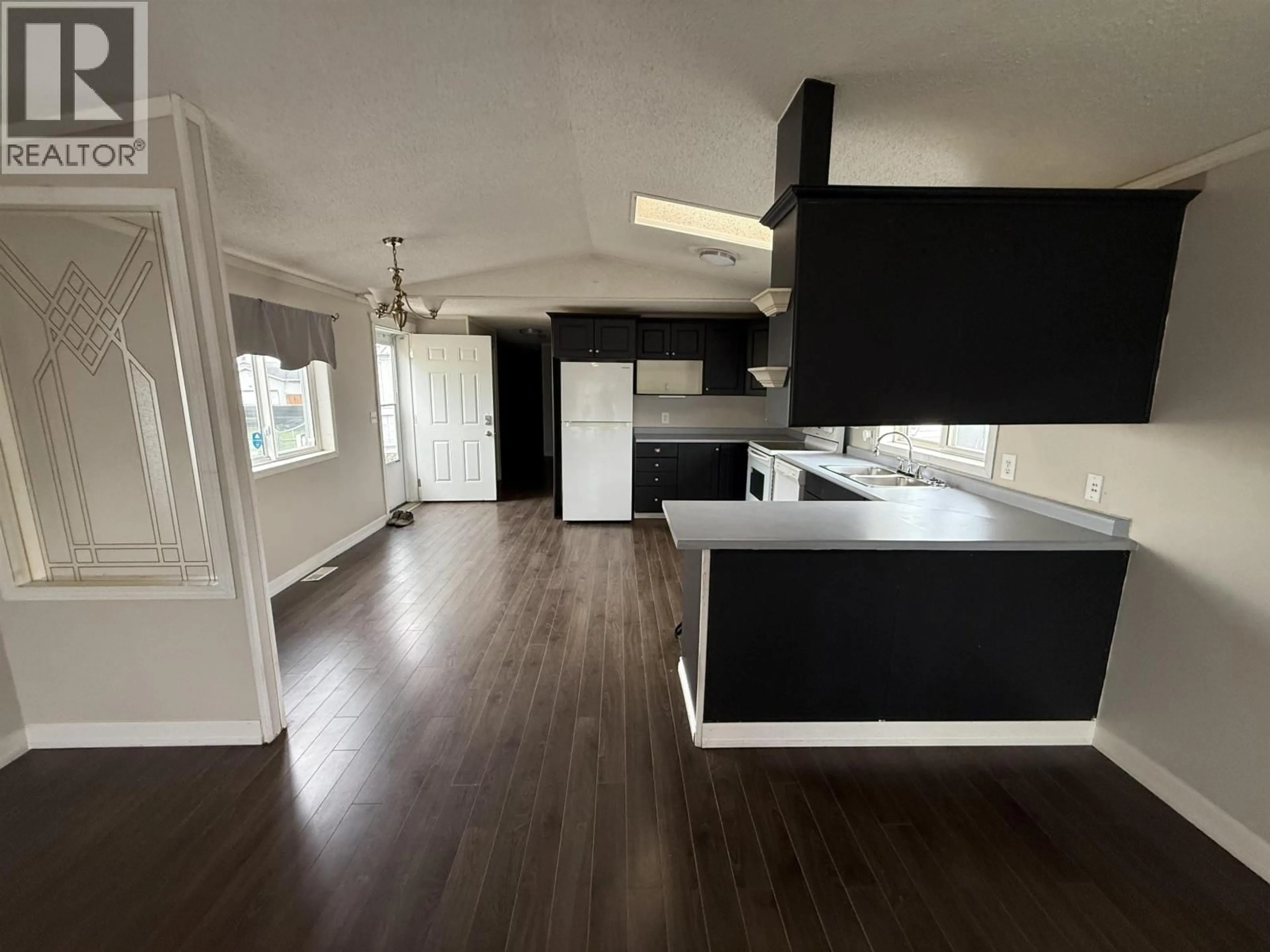 Open concept kitchen, wood/laminate floor for 172 - 9207 82 STREET, Fort St. John British Columbia V1J5G6