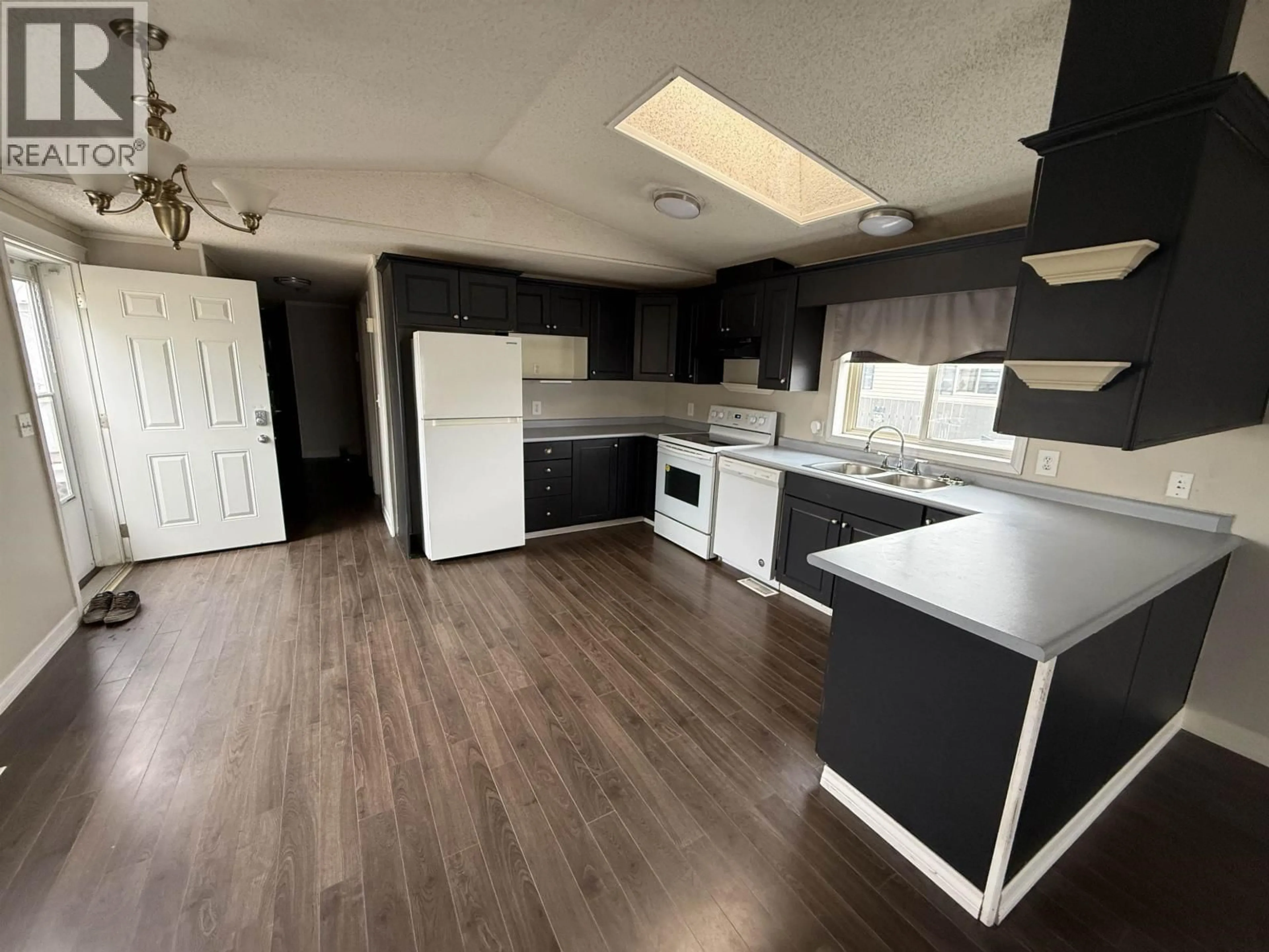 Open concept kitchen, wood/laminate floor for 172 - 9207 82 STREET, Fort St. John British Columbia V1J5G6