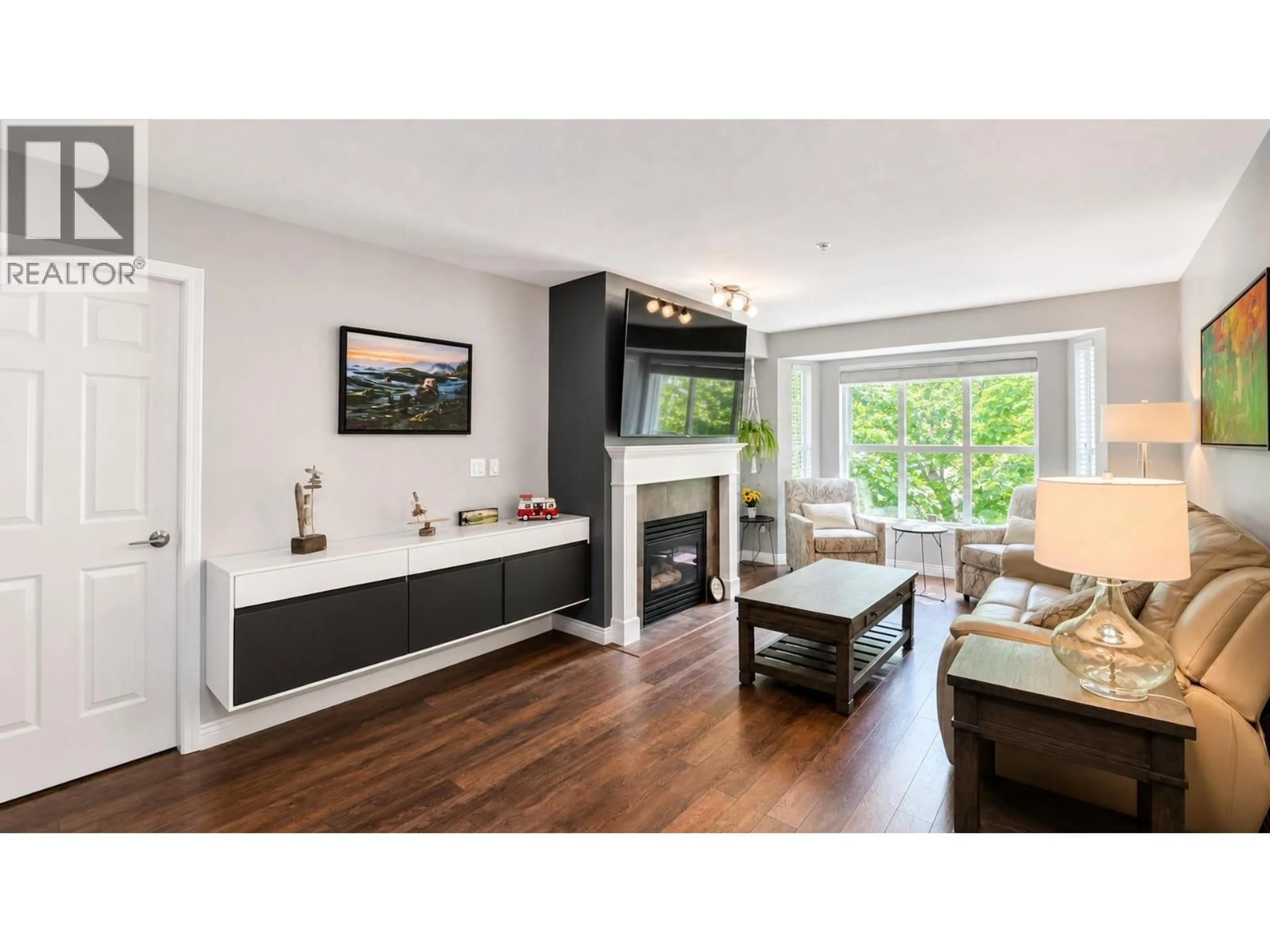Living room with furniture, wood/laminate floor for 306 - 2393 WELCHER AVENUE, Port Coquitlam British Columbia V3C1X6