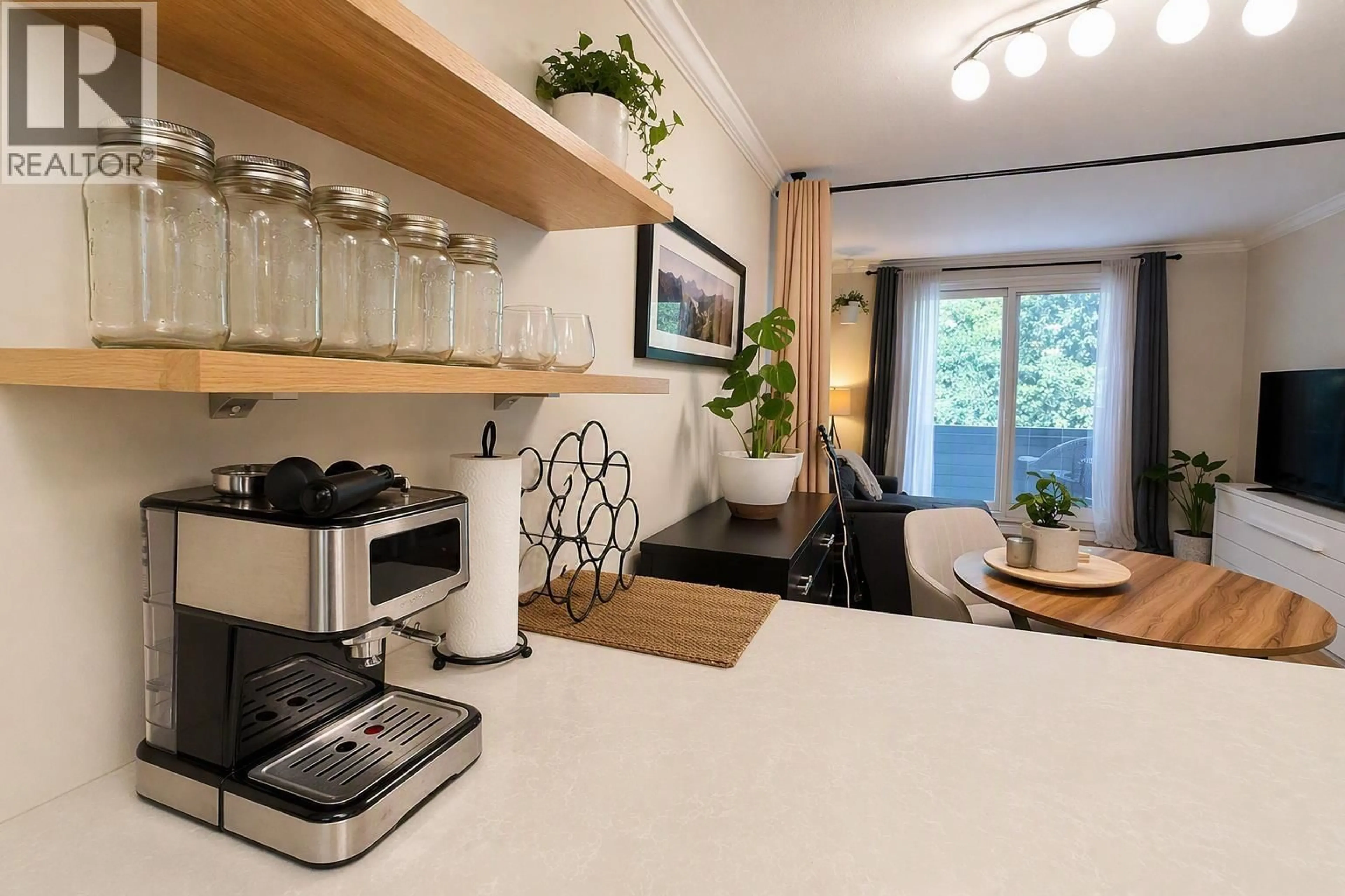 Open concept kitchen, wood/laminate floor for 106 - 2005 NORDIC PLACE, Whistler British Columbia V8E0N8