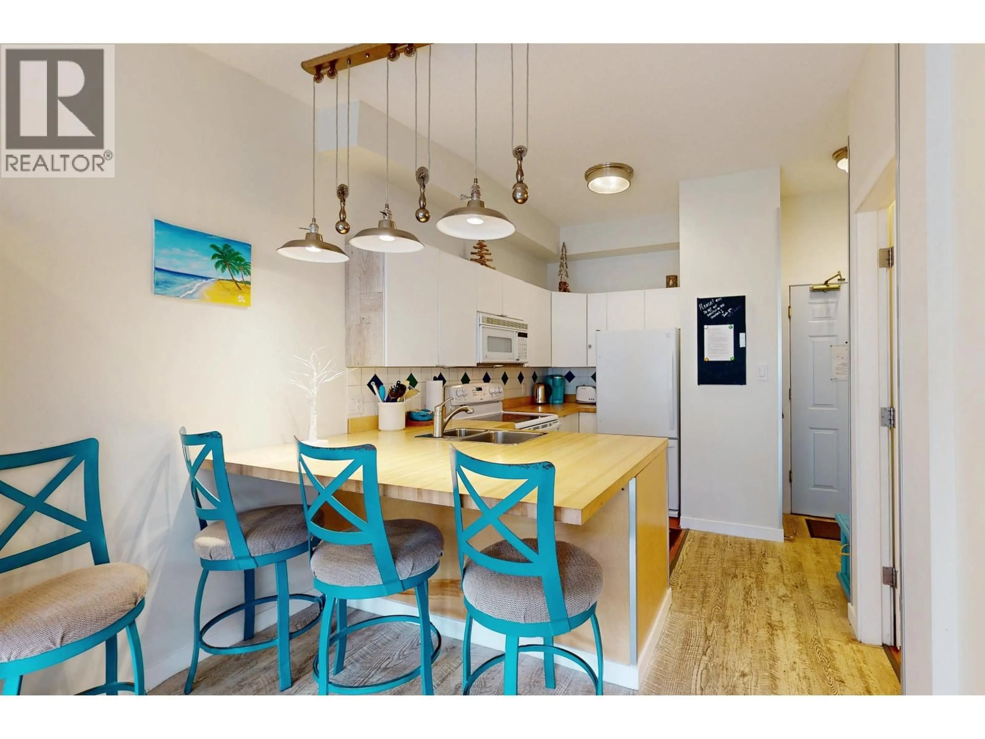 Open concept kitchen, wood/laminate floor for 303 - 4368 MAIN STREET, Whistler British Columbia V8E1B6