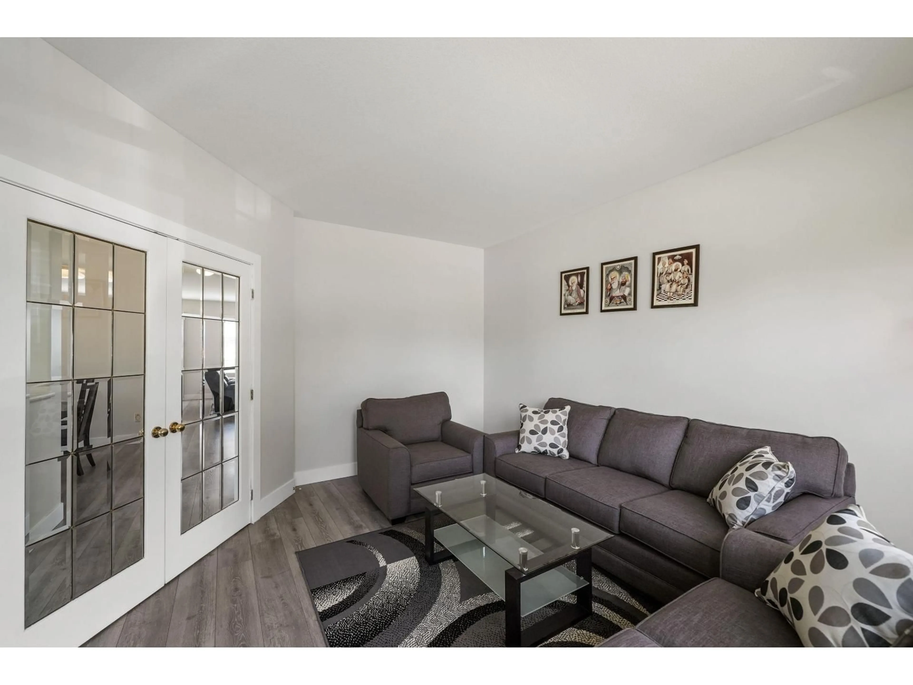 Living room with furniture, wood/laminate floor for 18568 64B AVENUE, Surrey British Columbia V3S8S9