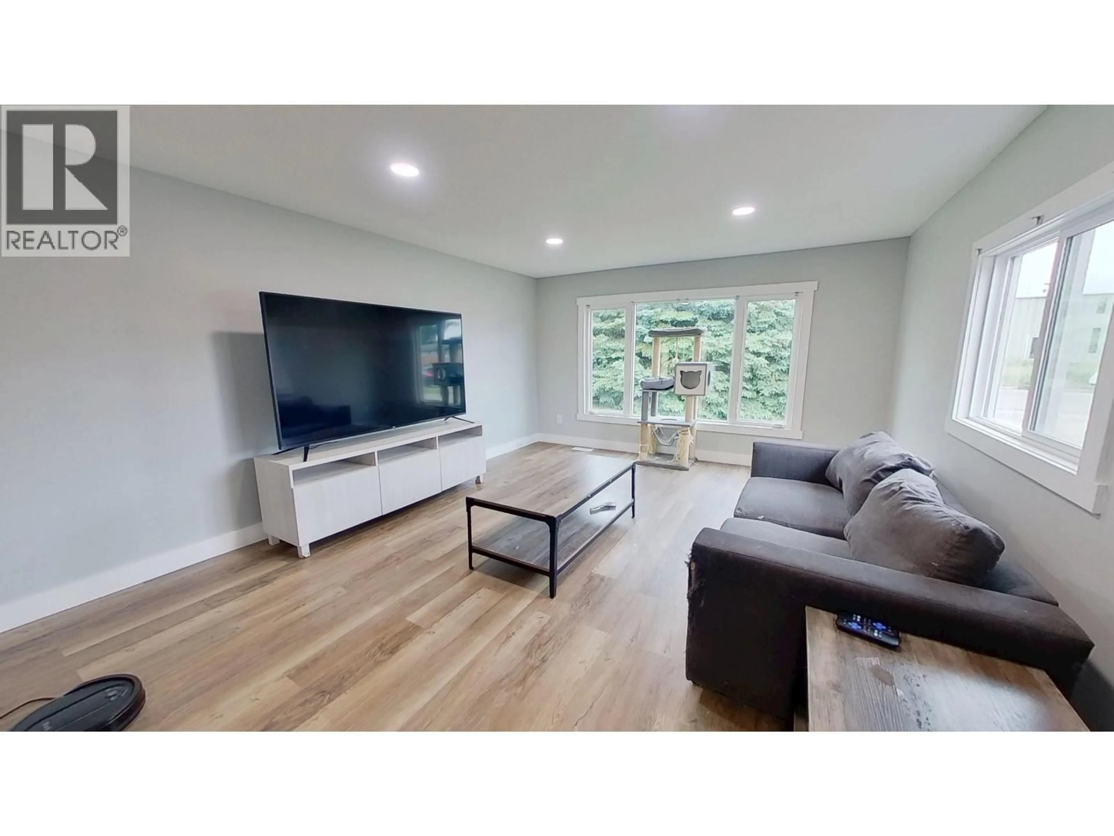 Living room with furniture, wood/laminate floor for 9108 75 STREET, Fort St. John British Columbia V1J4N9