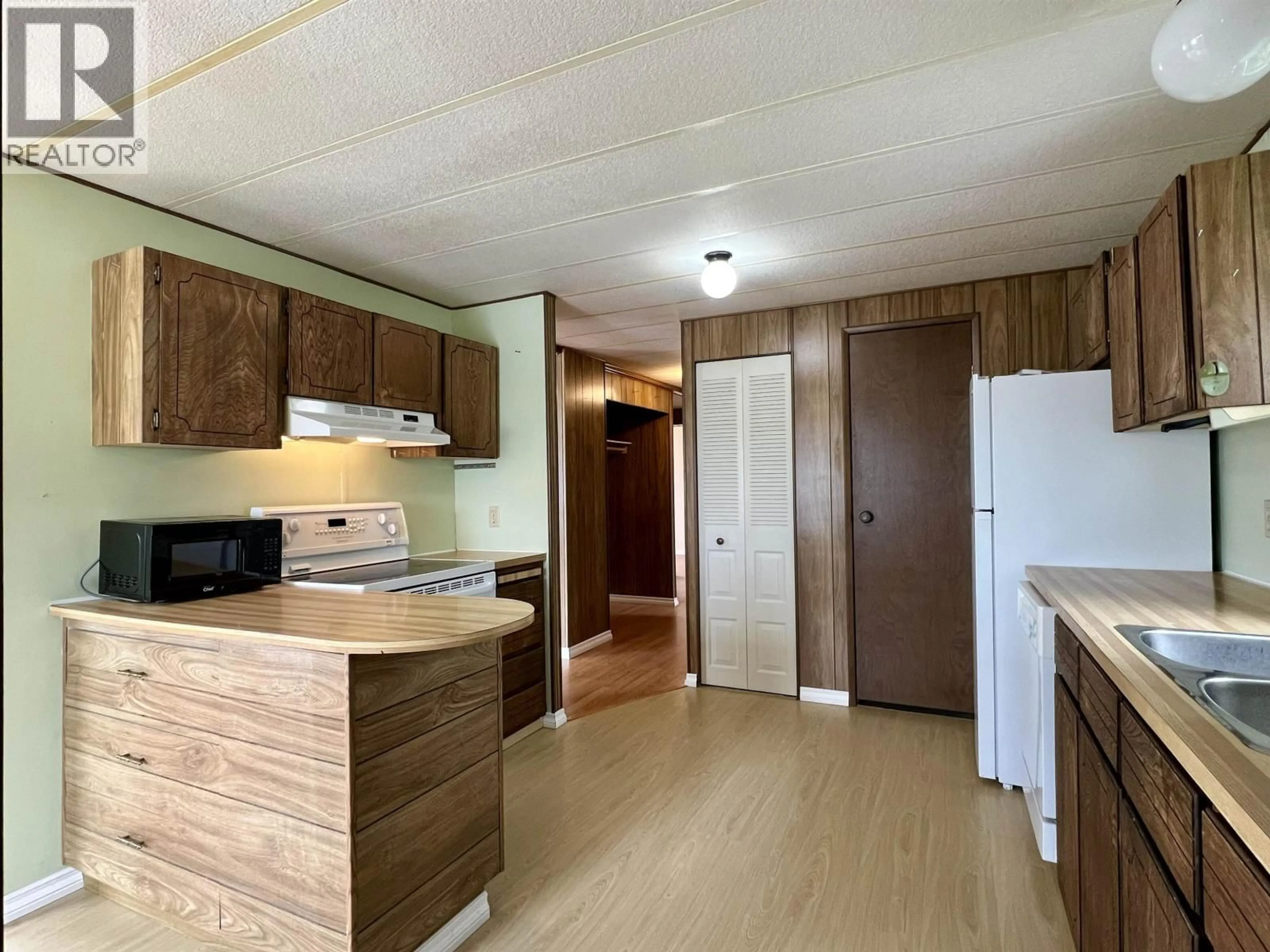 Standard kitchen, wood/laminate floor for 32 - 375 HORSE LAKE ROAD, 100 Mile House British Columbia V0K2E0