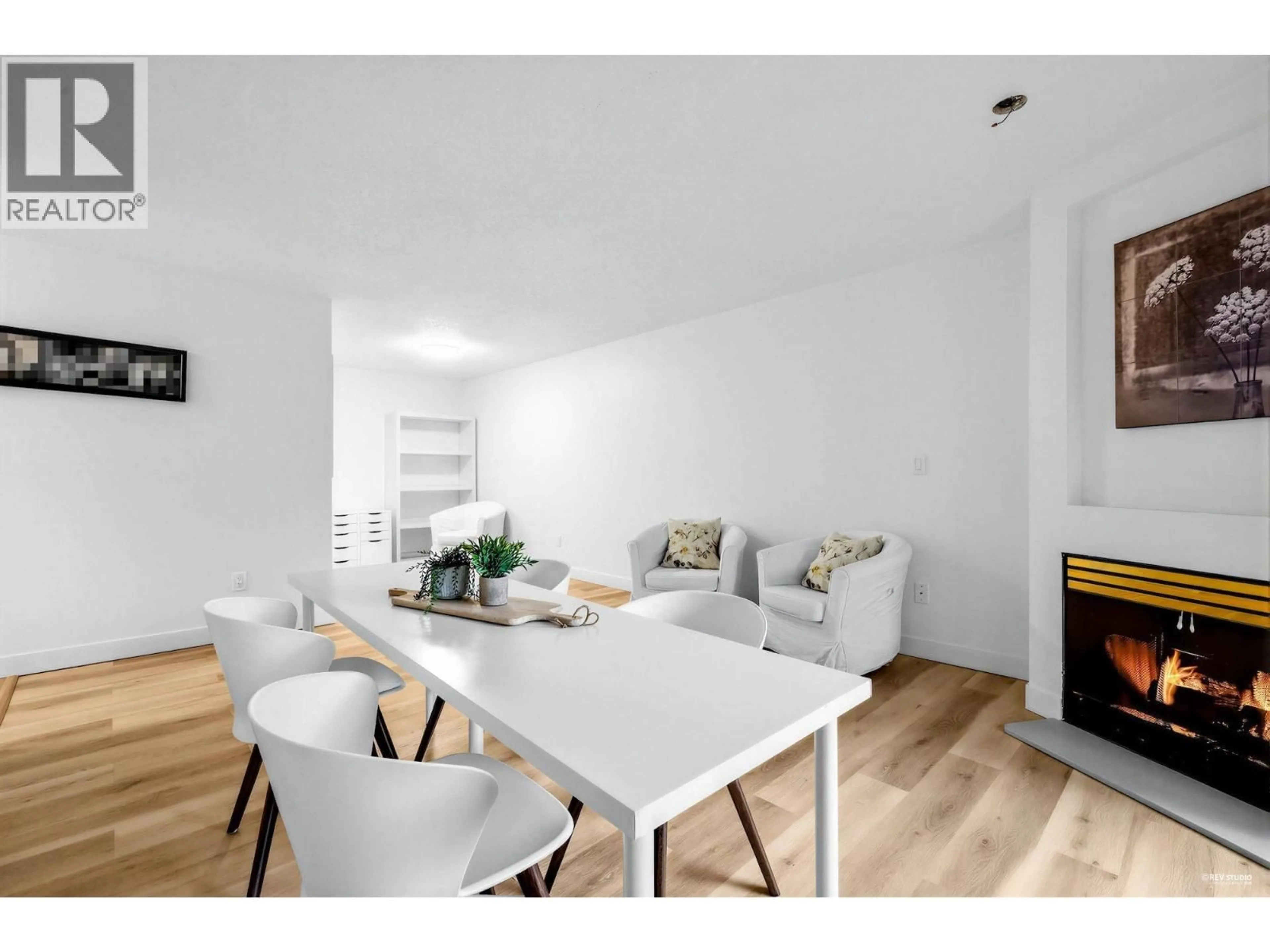 Living room with furniture, wood/laminate floor for 107 - 2925 GLEN DRIVE, Coquitlam British Columbia V3B7H9