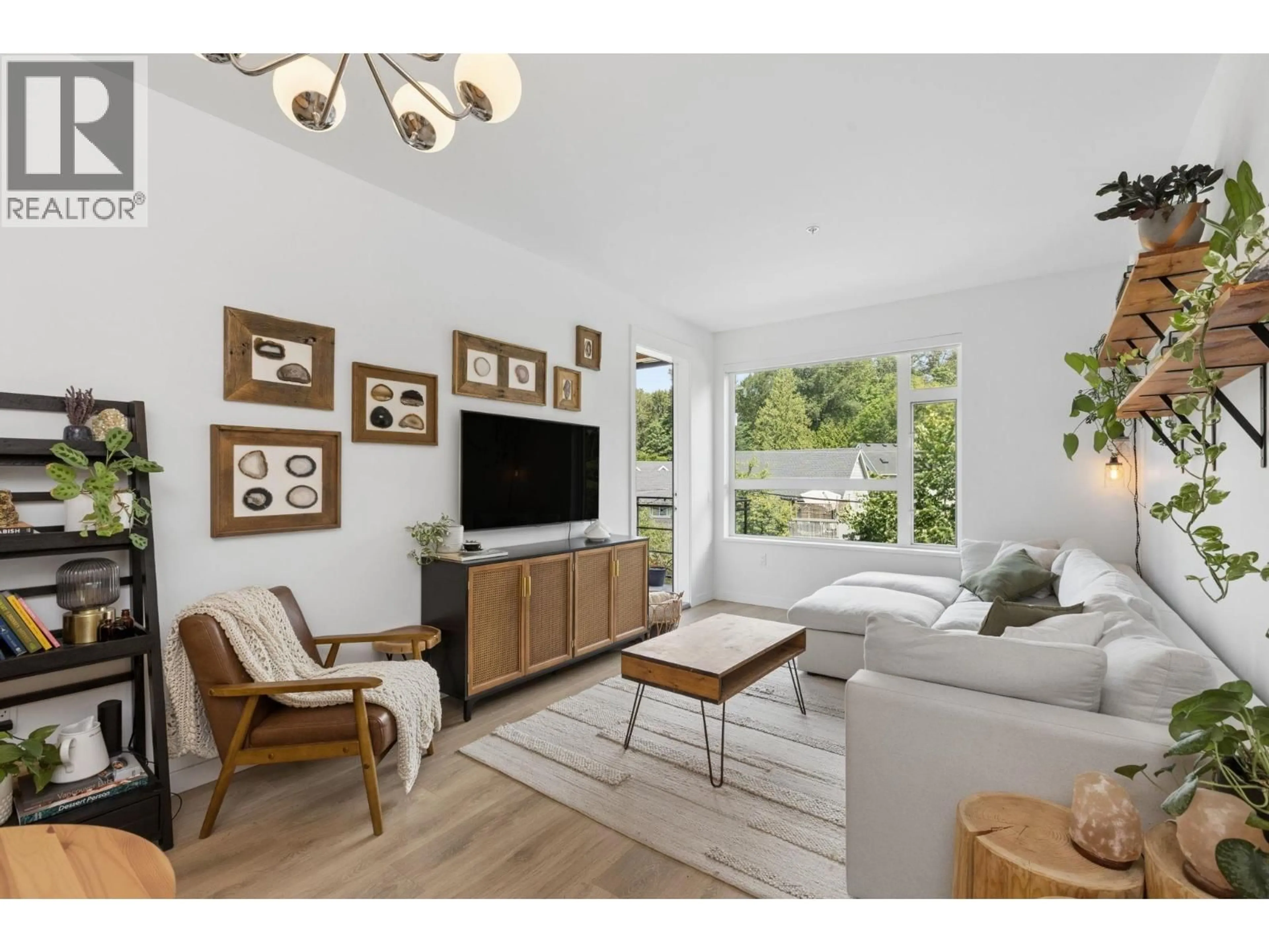 Living room with furniture, wood/laminate floor for 209 - 715 15TH STREET, North Vancouver British Columbia V7M1T2