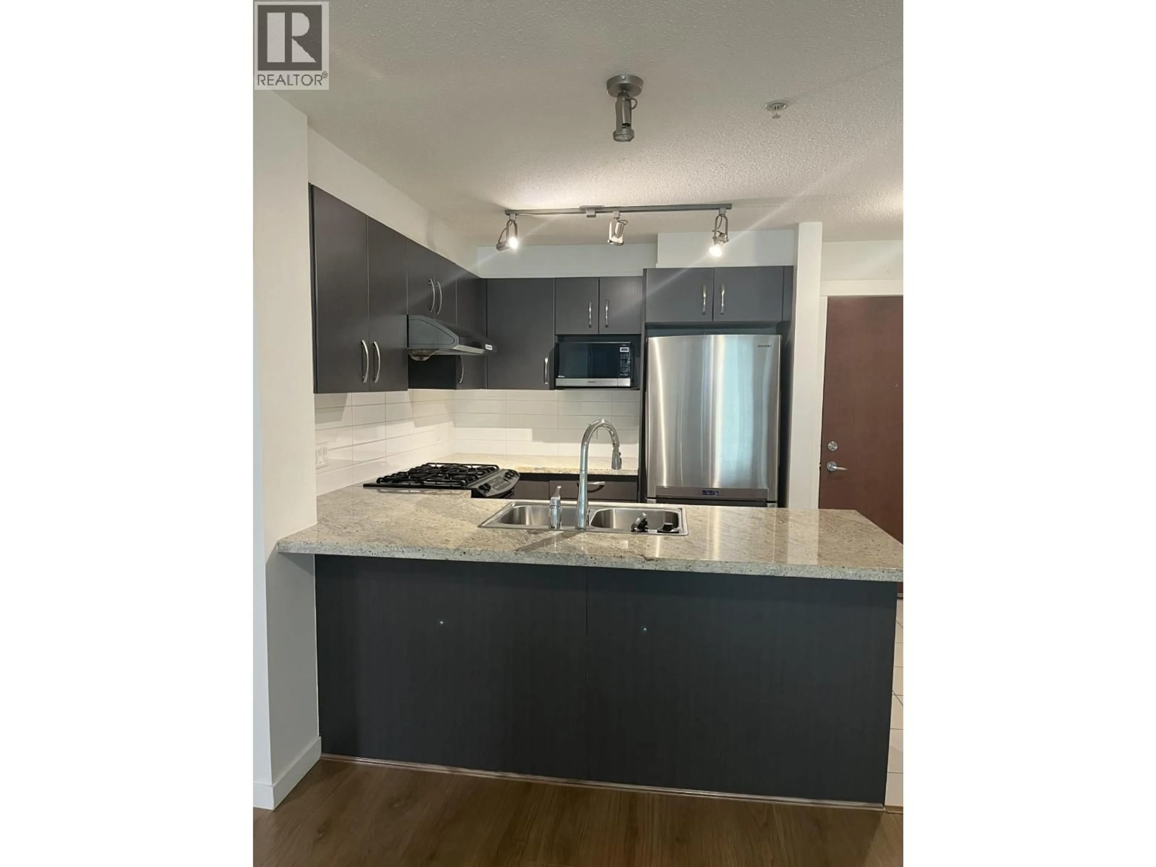 Open concept kitchen, wood/laminate floor for 111 - 9299 TOMICKI AVENUE, Richmond British Columbia V6X0C5