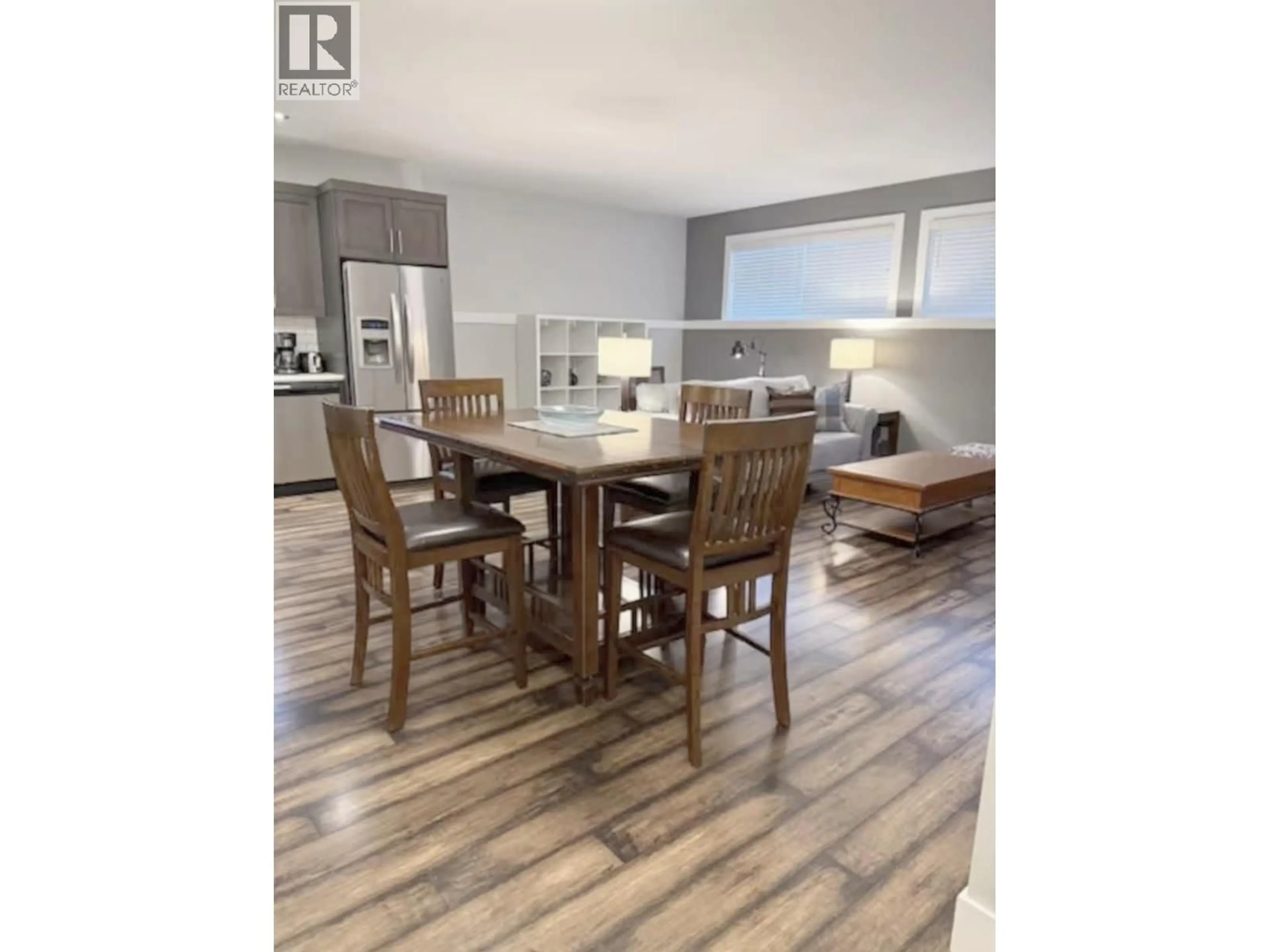 Open concept kitchen, wood/laminate floor for A - 8311 88 AVENUE, Fort St. John British Columbia V1J0N9