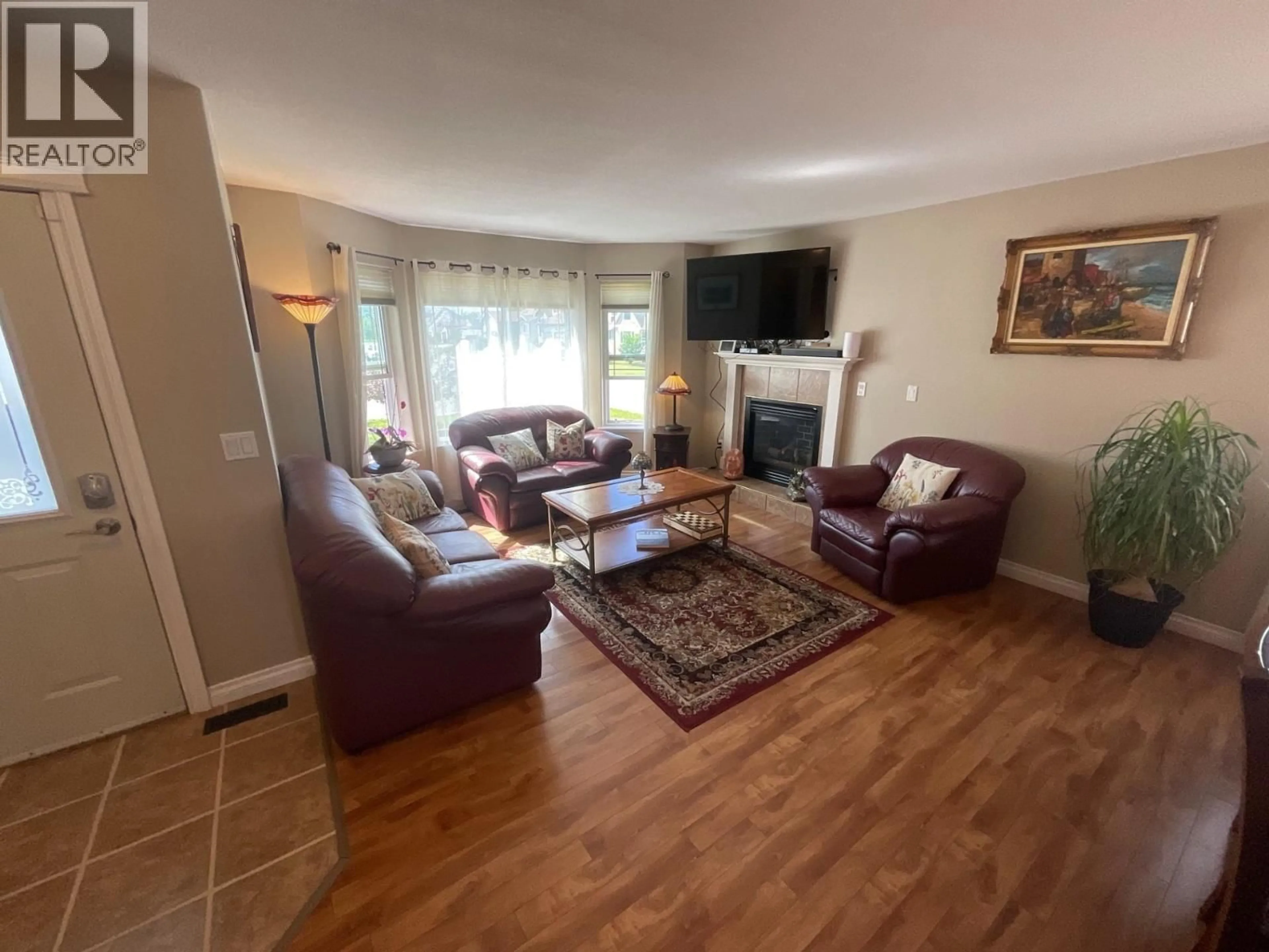 Living room with furniture, wood/laminate floor for 11411 98 STREET, Fort St. John British Columbia V1J7B5