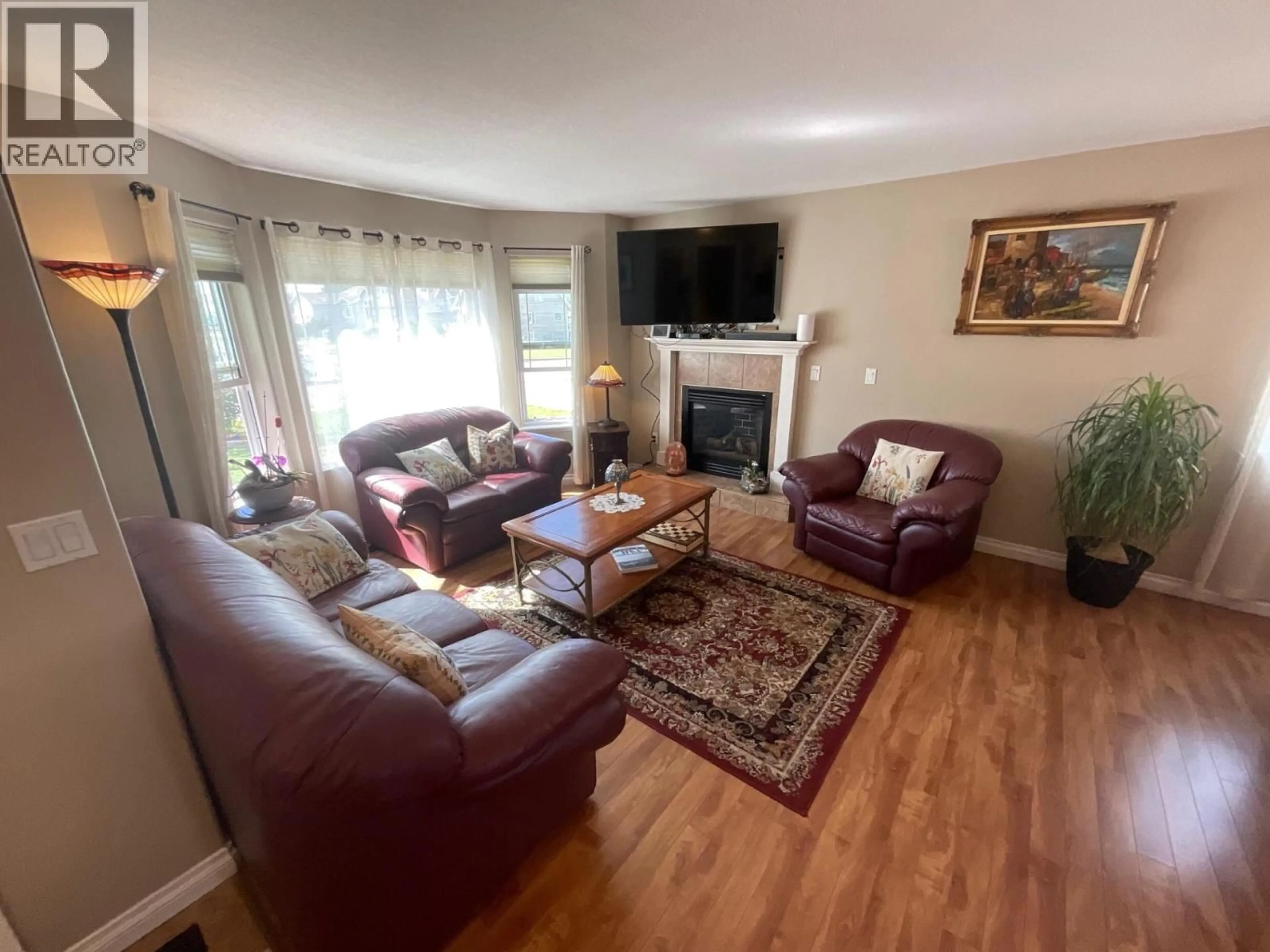 Living room with furniture, wood/laminate floor for 11411 98 STREET, Fort St. John British Columbia V1J7B5